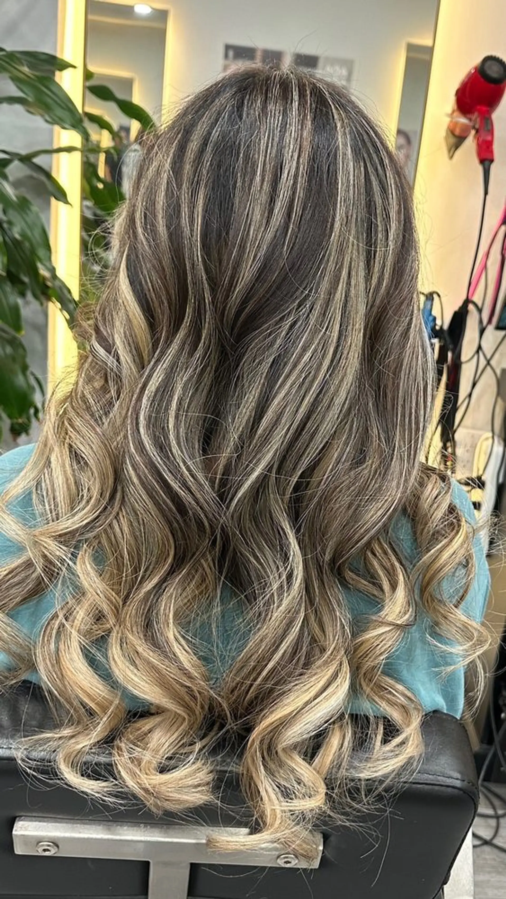 Long wavy hair with caramel and blonde highlights in a soft balayage. 1