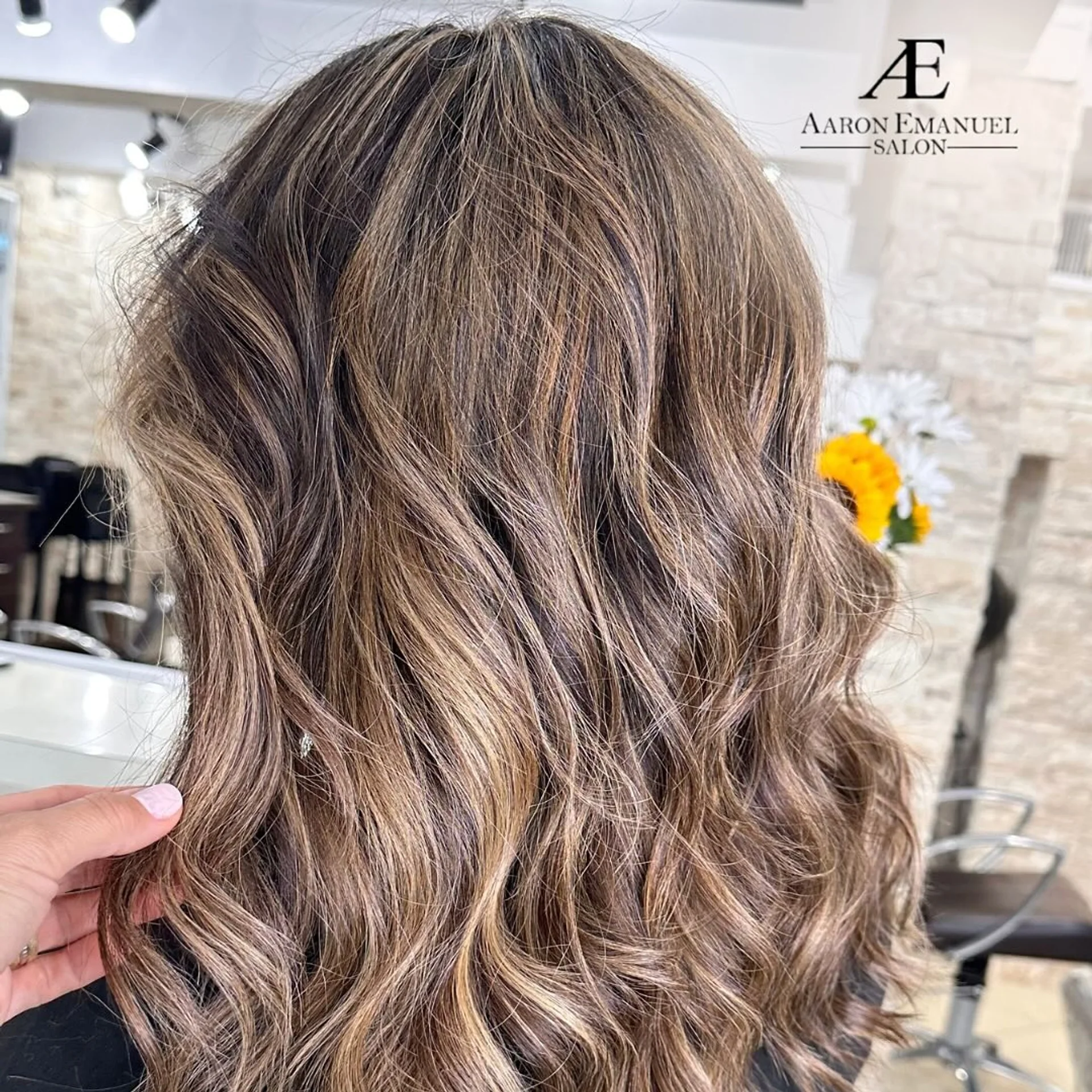 A woman with a modern, medium-length retro shag haircut with face-framing curtain bangs and sun-kissed blonde highlights. - Preview 3