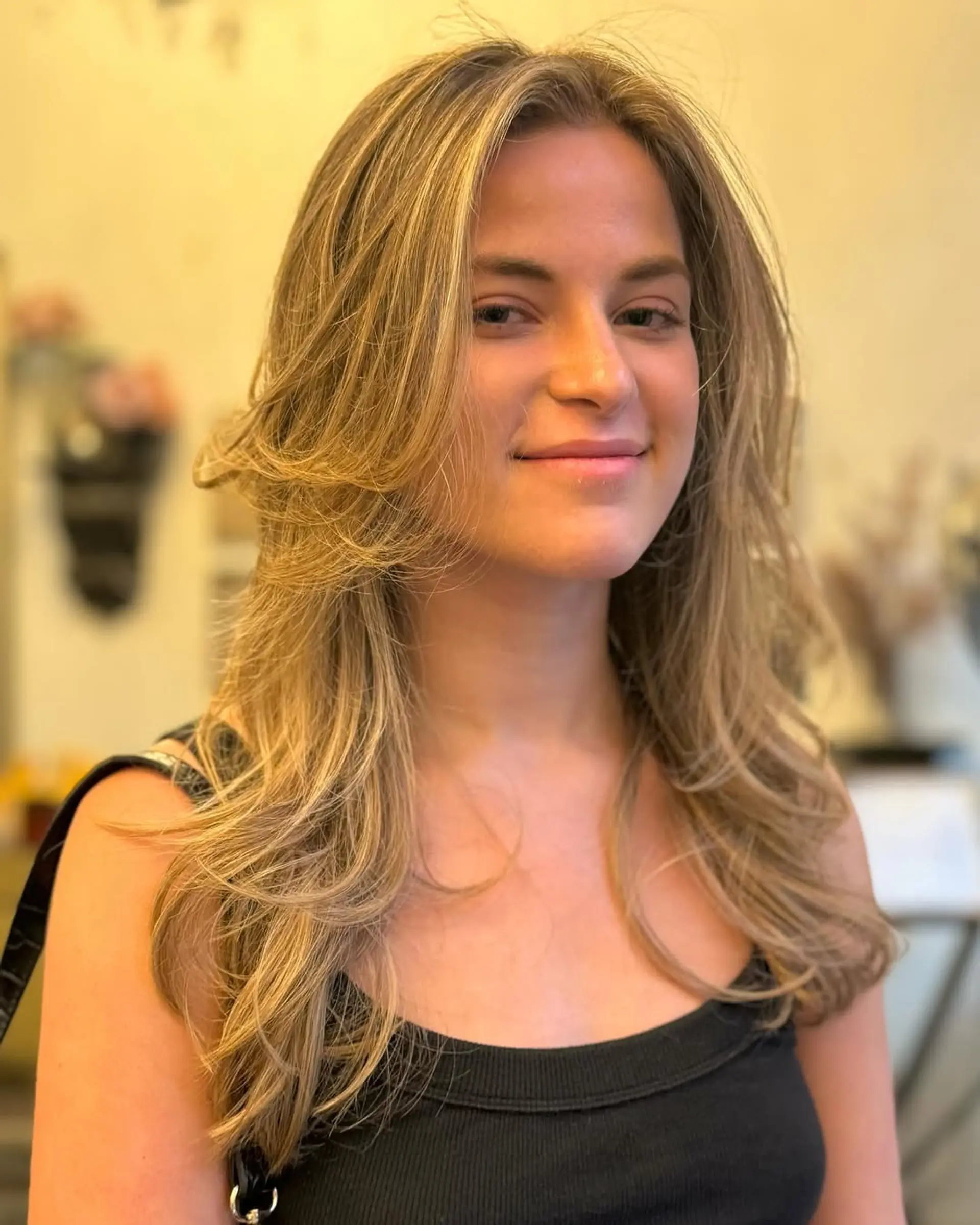 Long, golden blonde, softly layered waves with a radiant shine and natural flow. 2