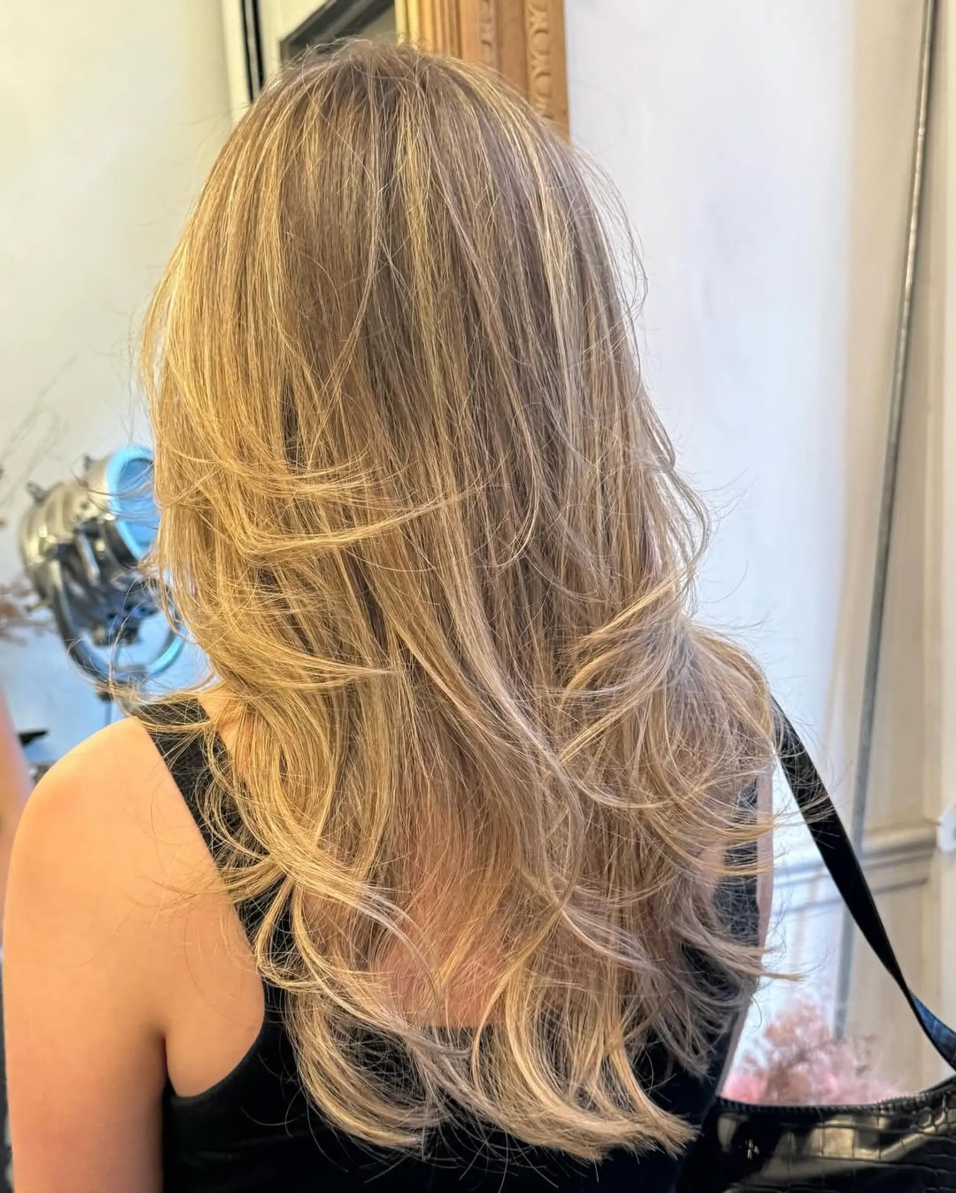 Long, golden blonde, softly layered waves with a radiant shine and natural flow. 1
