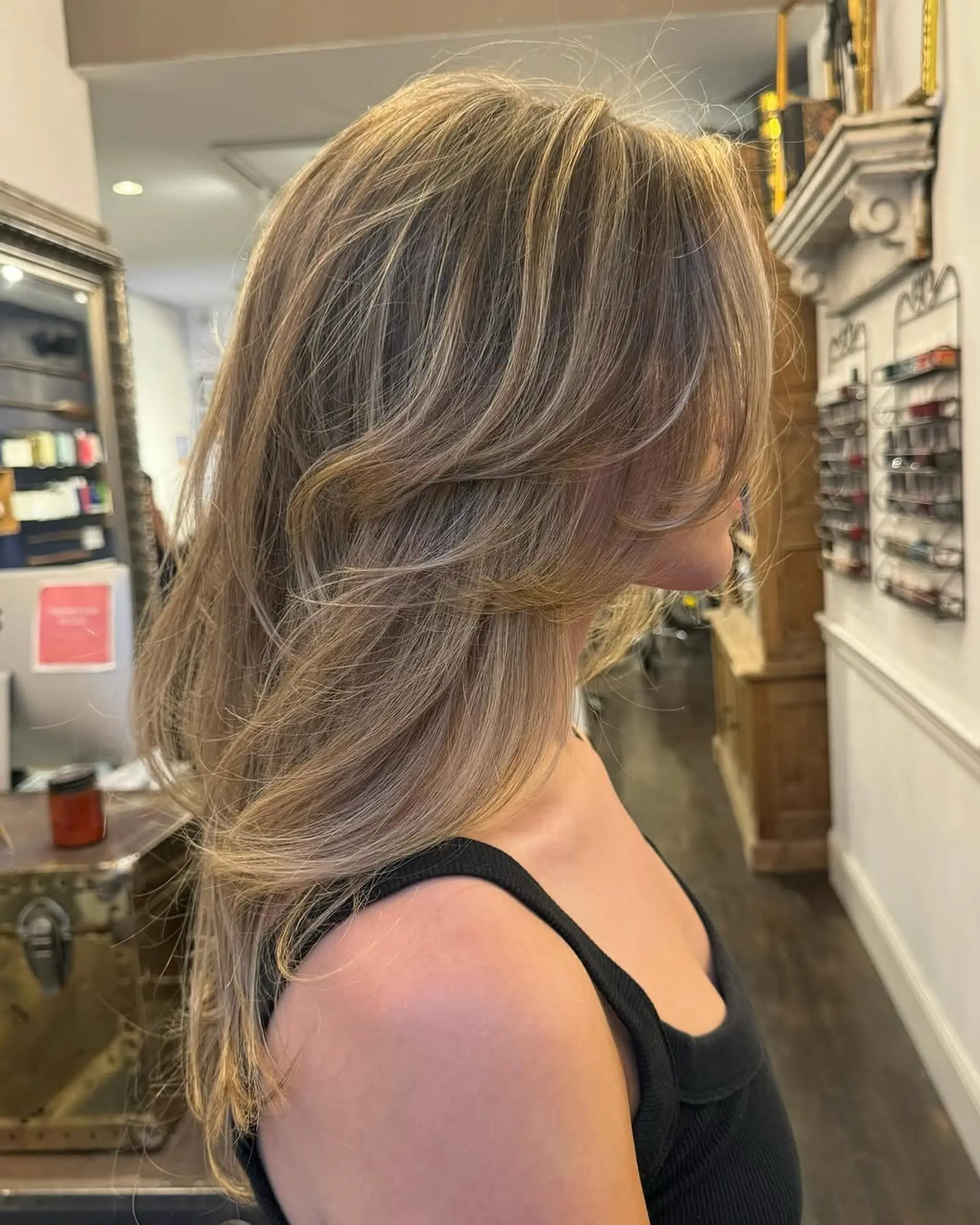 Long, golden blonde, softly layered waves with a radiant shine and natural flow. 3