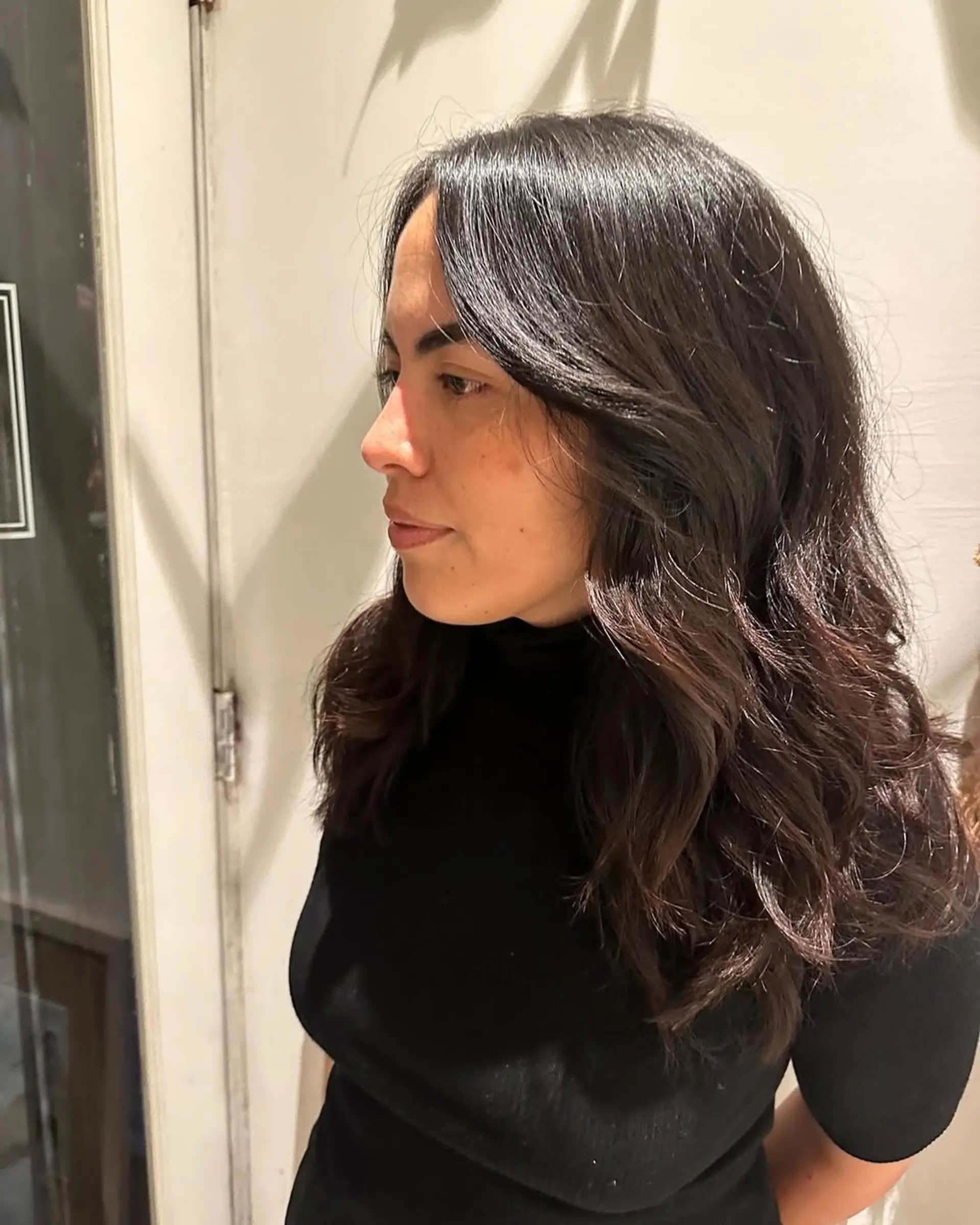 Long, layered hair with soft waves and face-framing layers. 1