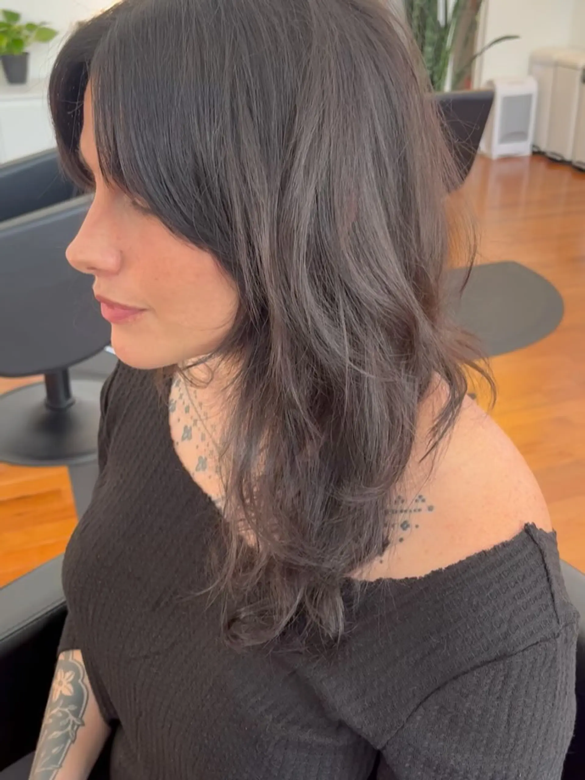 A textured, 90s-inspired long layered haircut featuring face-framing curtain bangs and soft, natural movement throughout. 1