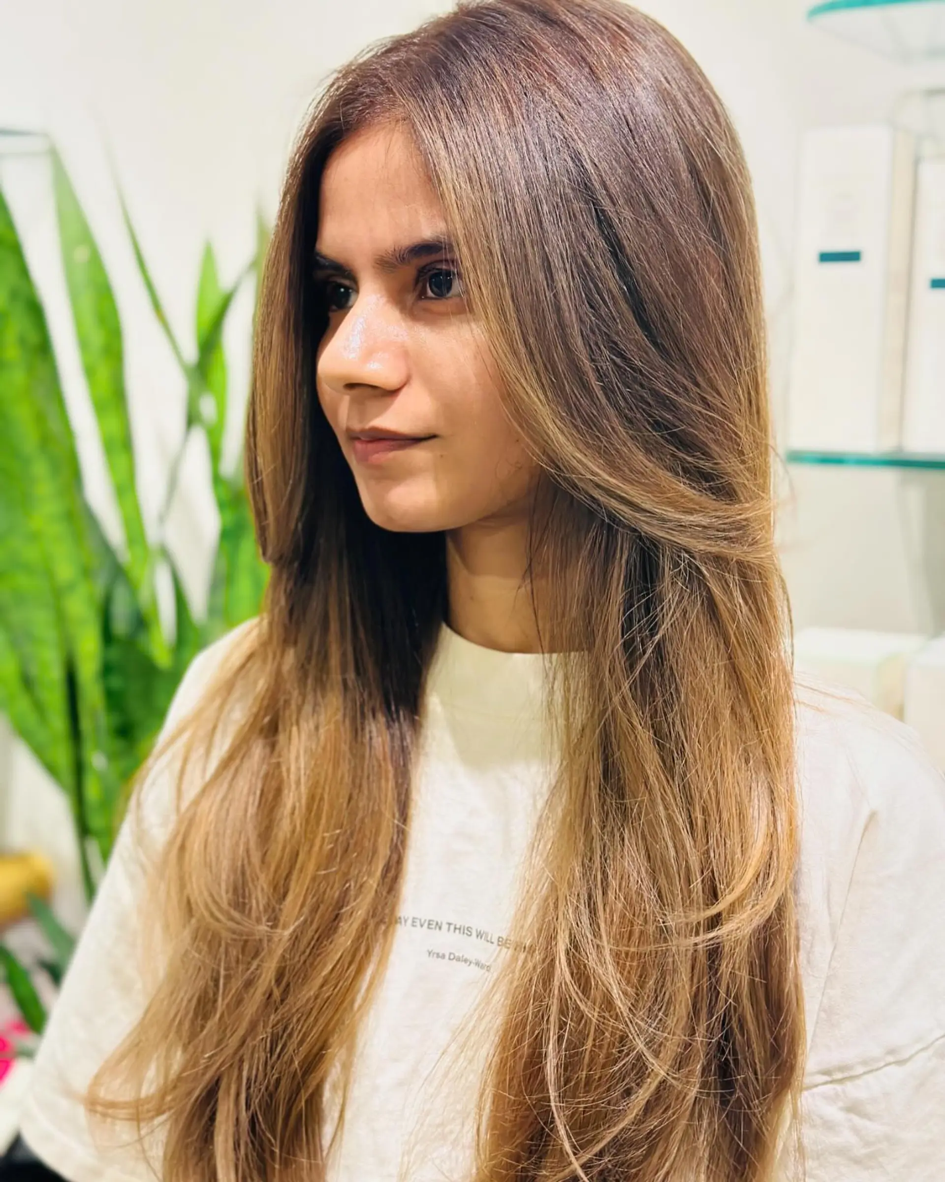 Long haircut cut into smooth, flowy layers with soft face-framing sections styled in a rounded blowout. 1