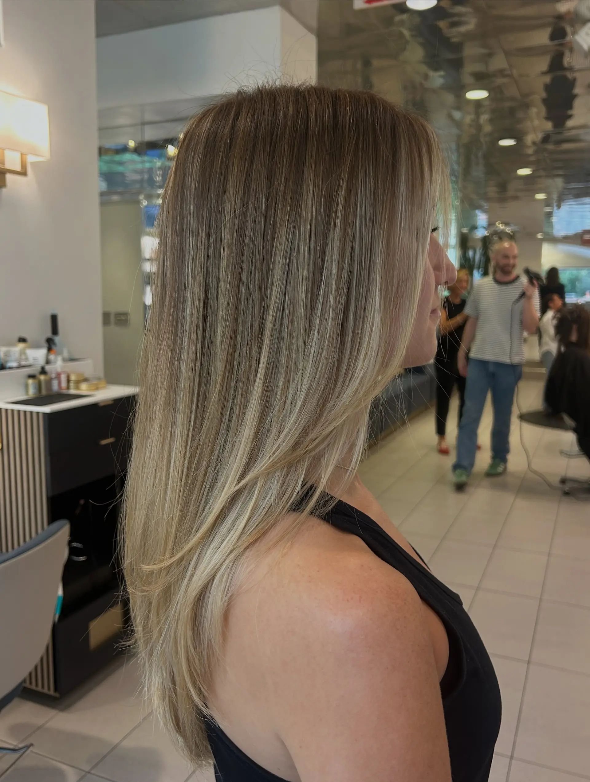 Long, sleek straight blonde hair with subtle face-framing layers and multi-tonal balayage highlights. 1