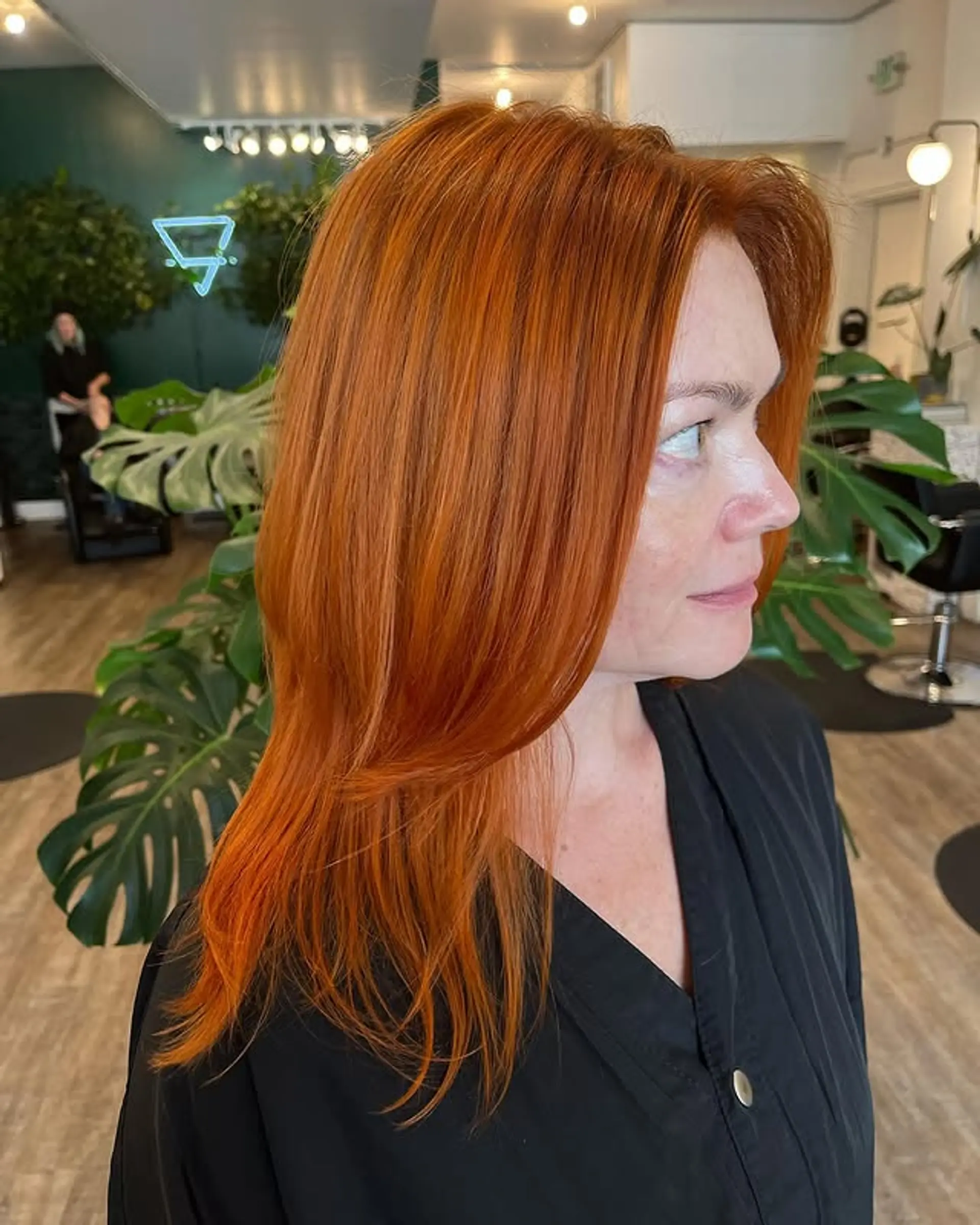 A medium-length hairstyle featuring cascading layers for a face-framing effect. 1