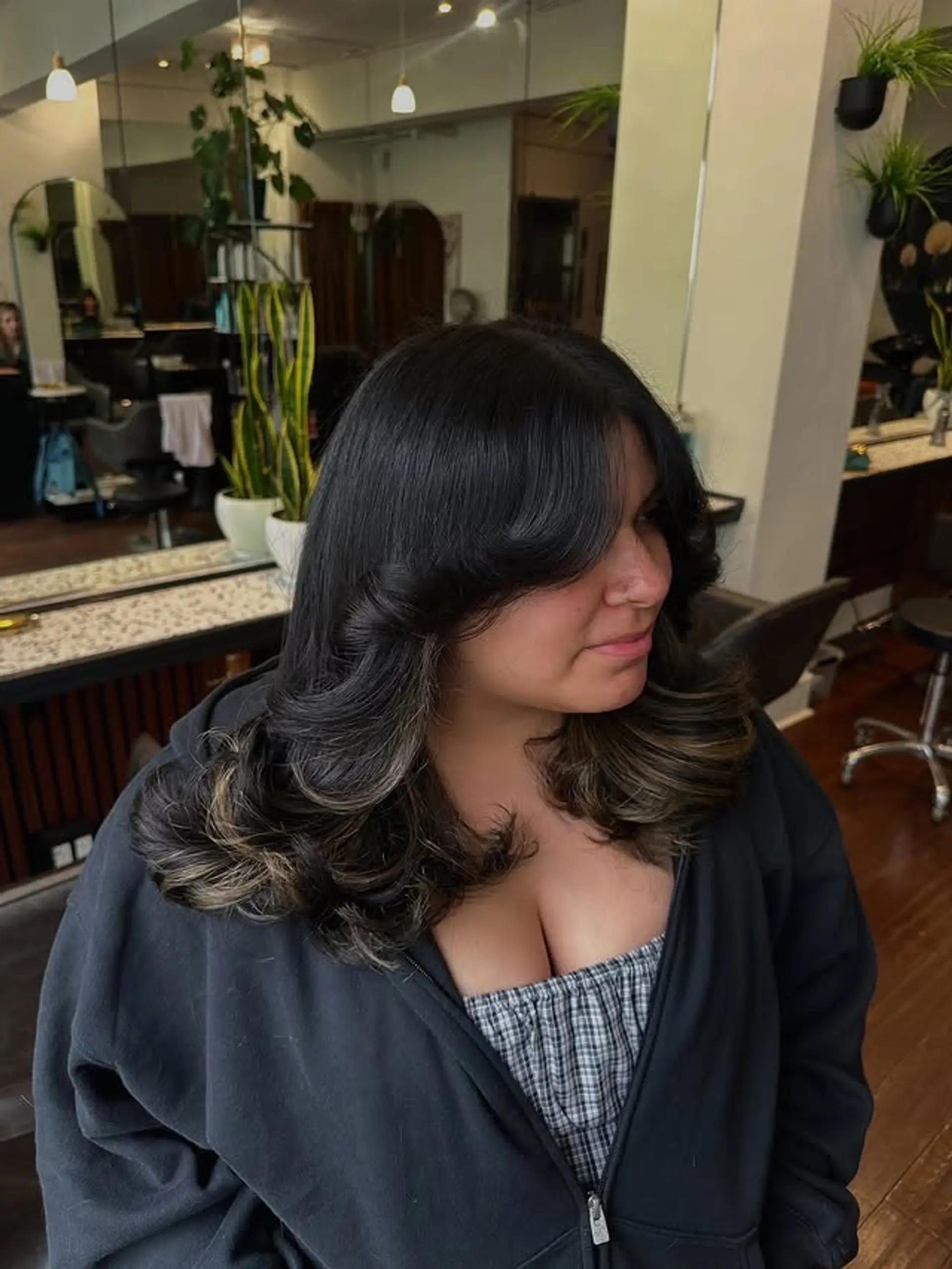 A medium-length layered haircut with face-framing layers and curtain bangs. 1