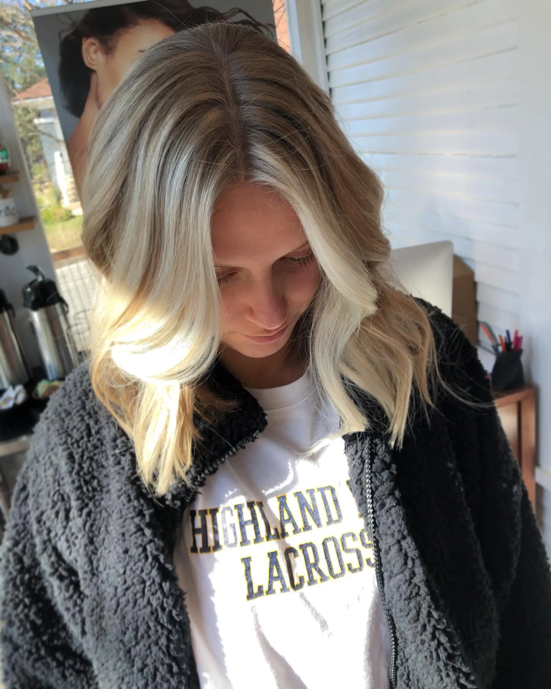 Medium-length blonde lob featuring bright face-framing highlights and loose, dimensional waves. 1