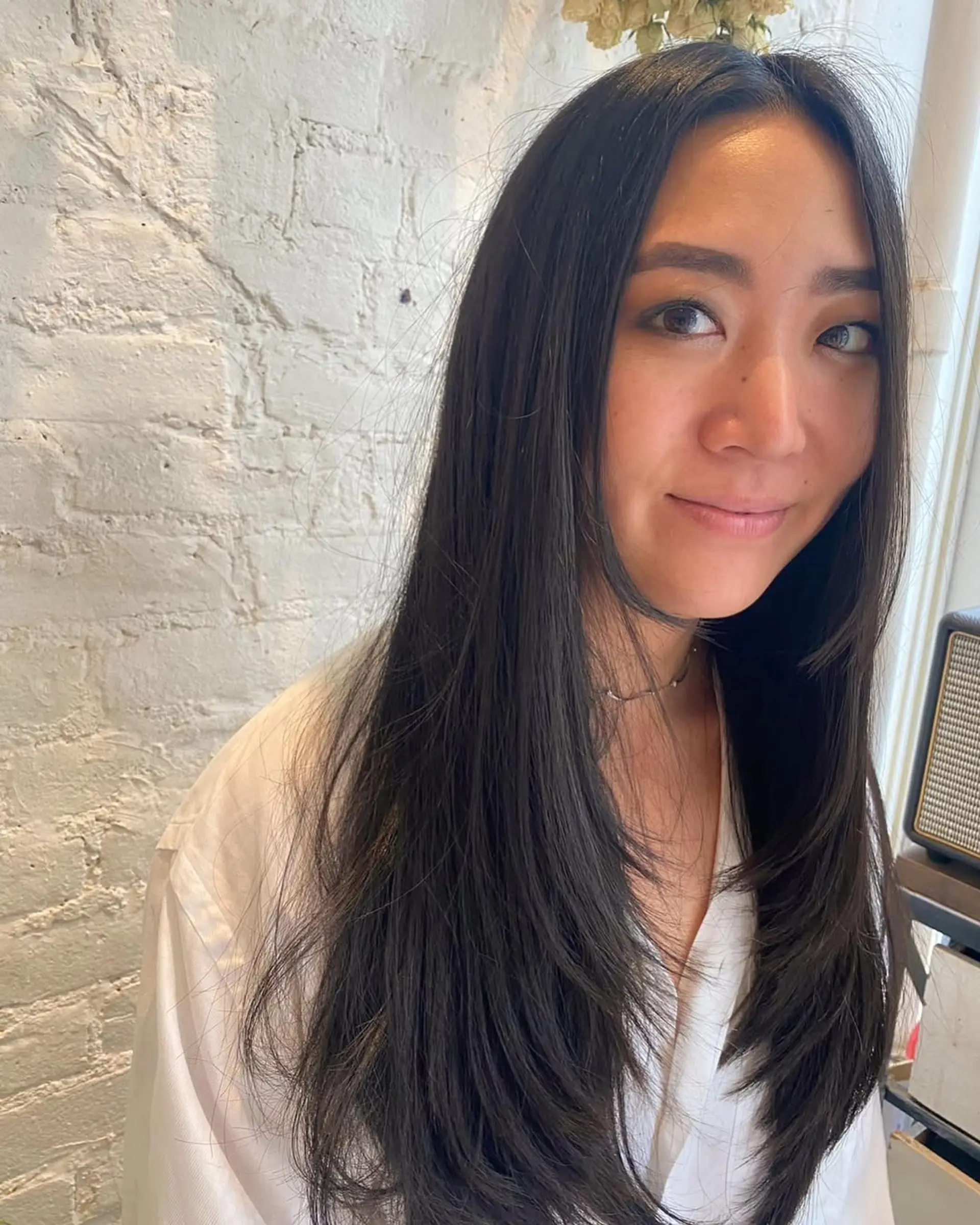 Long layered hairstyle with face-framing layers. 1