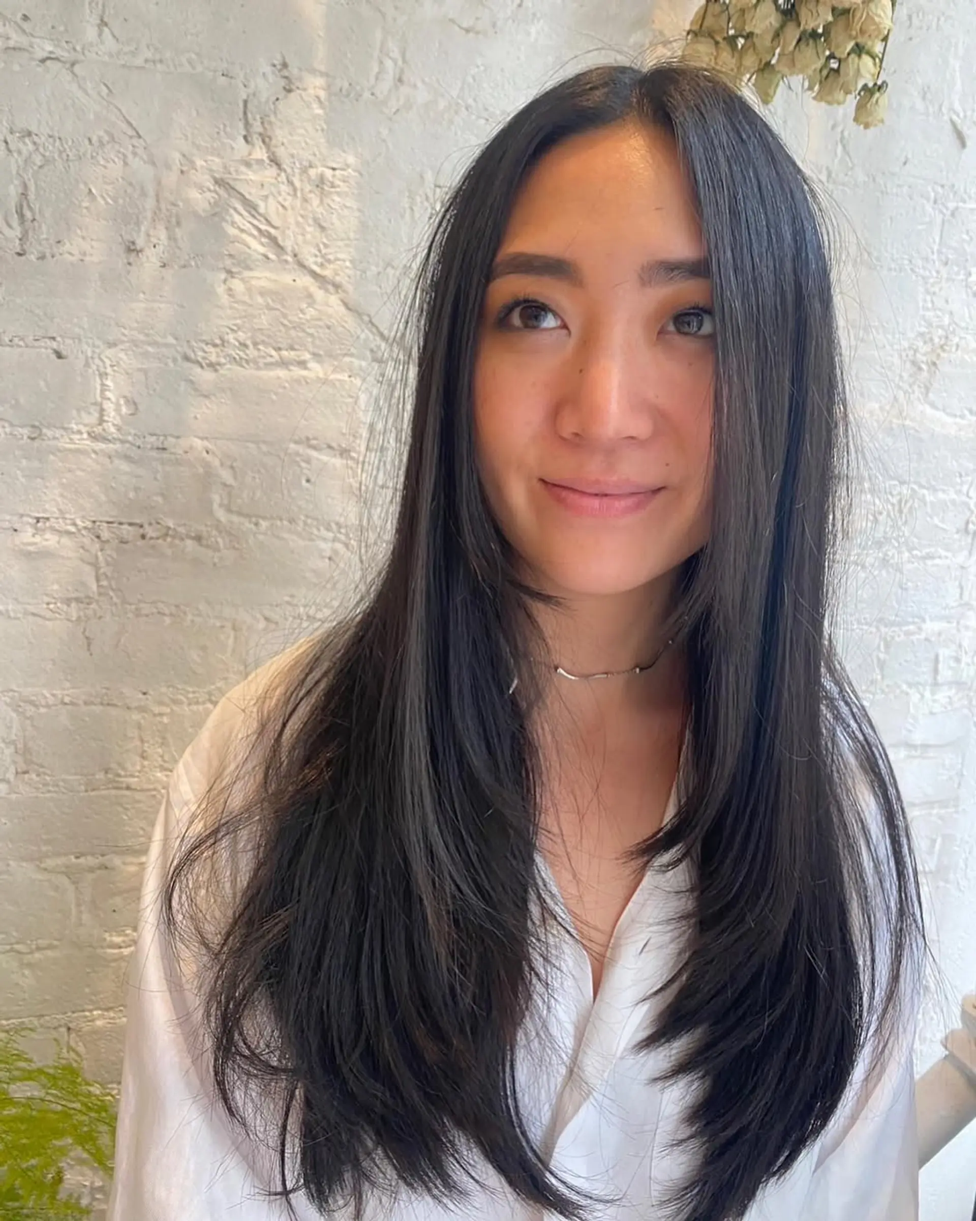 Long layered hairstyle with face-framing layers. 2