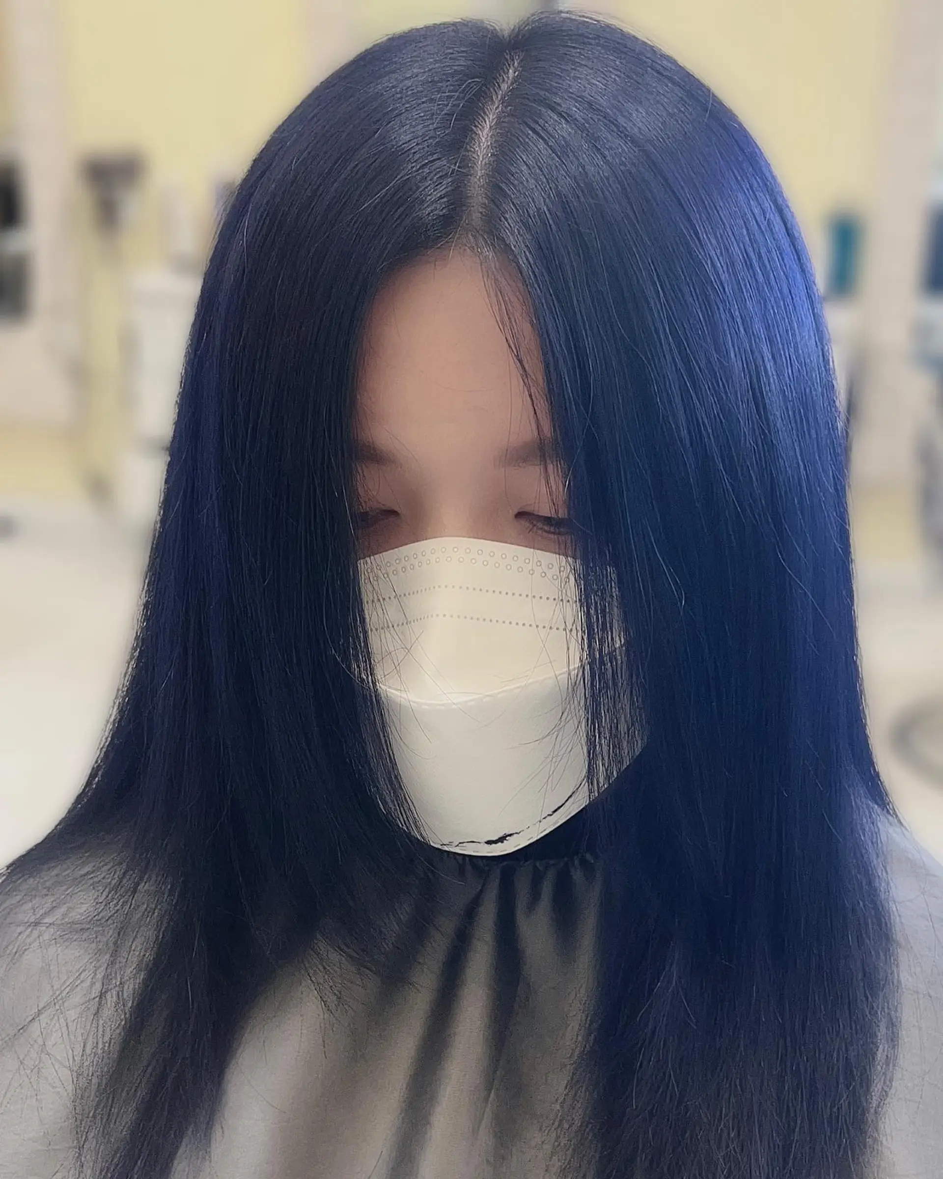 Long, straight hair dyed a vibrant midnight blue. 2