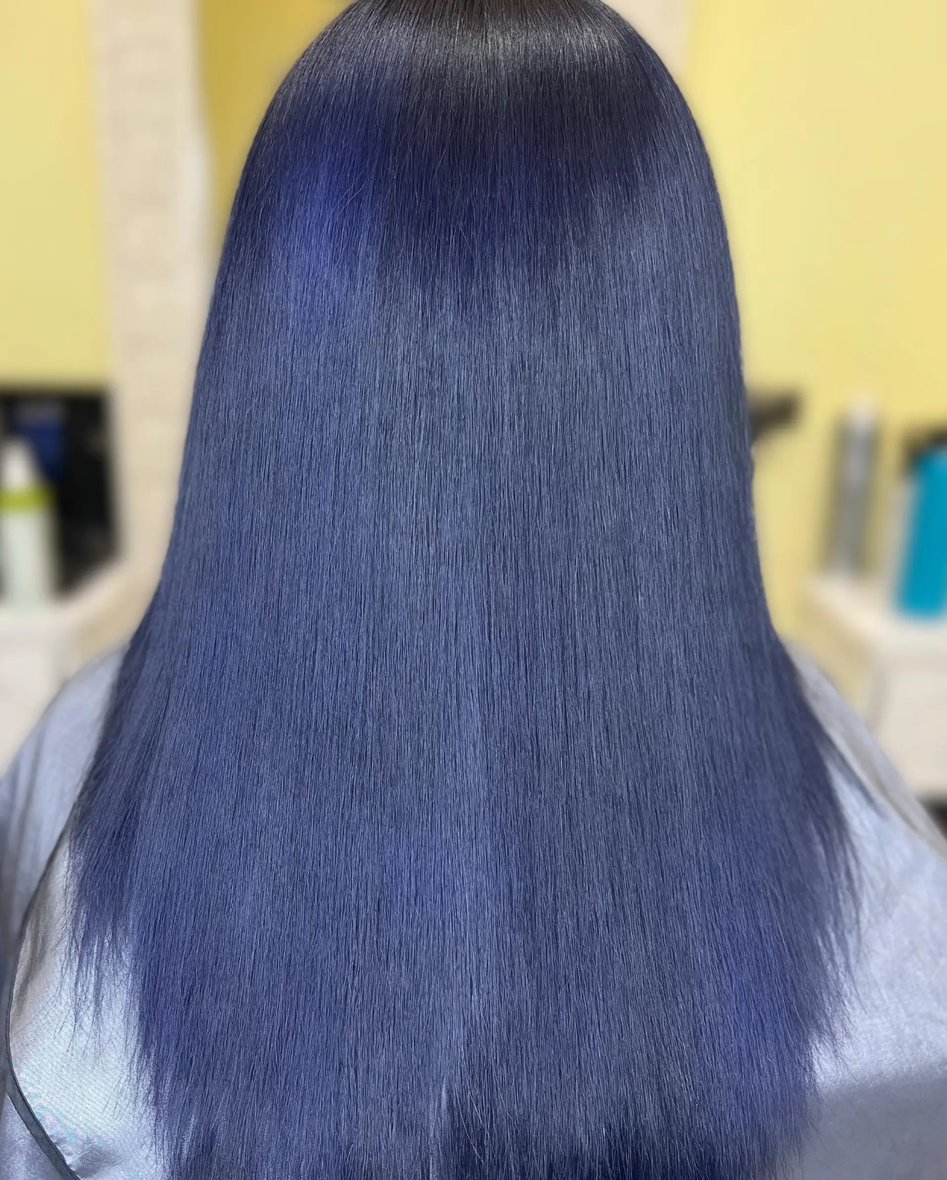 Long, straight hair dyed a vibrant midnight blue. 3