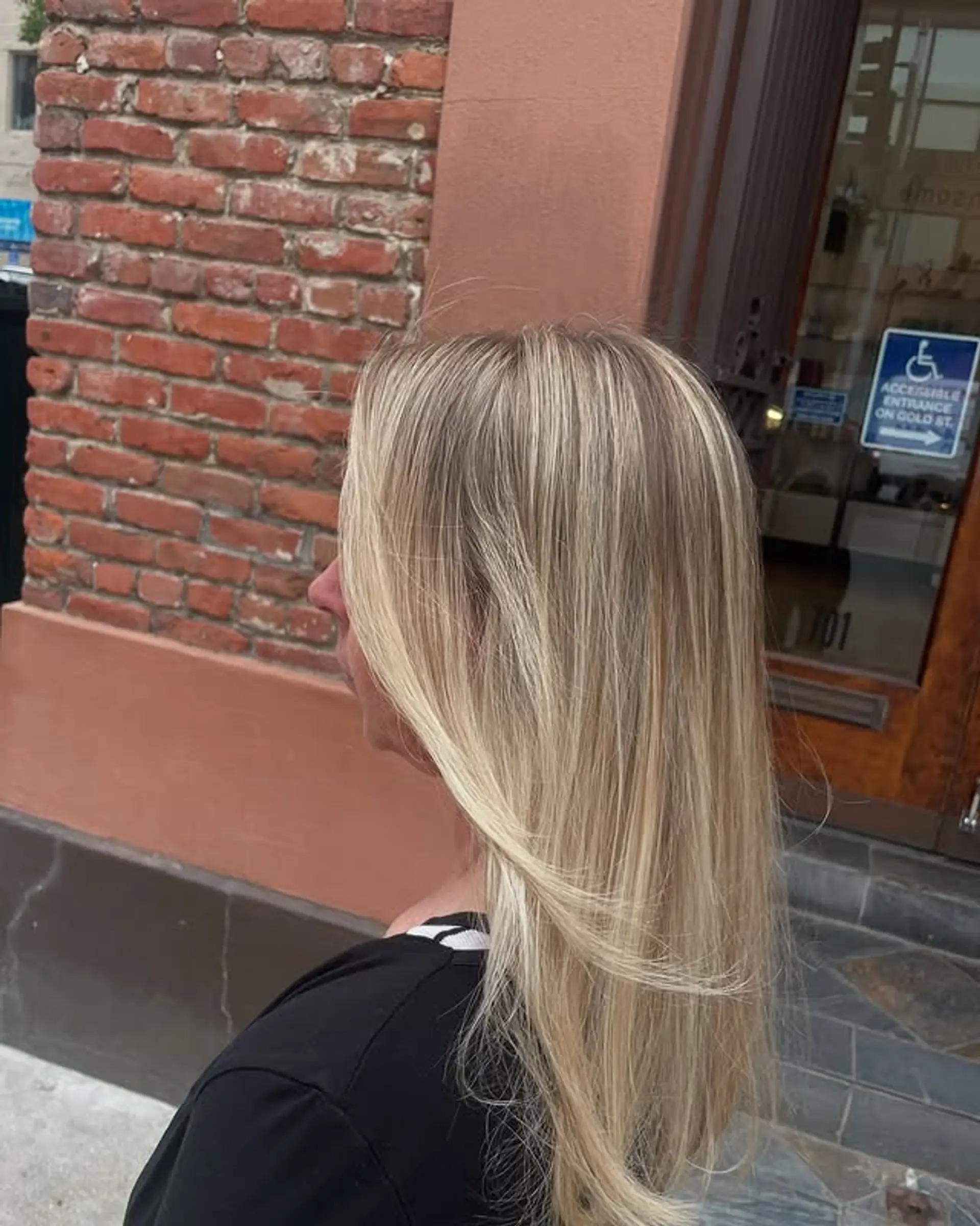 A long, layered bronde hairstyle with blonde highlights and face-framing layers. 1