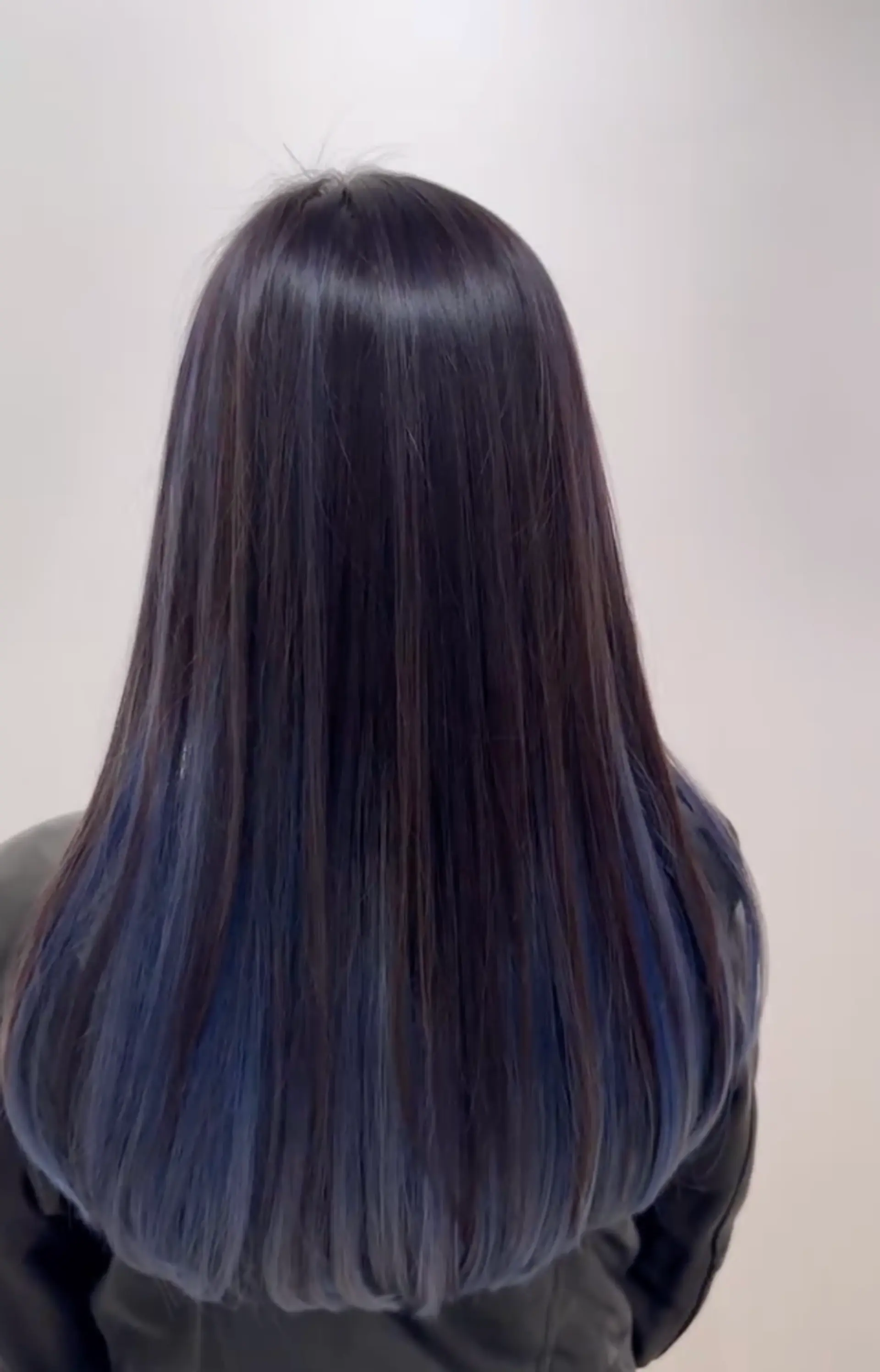 Long, straight hairstyle with an ombre transition from black to blue, featuring sleek and shiny layers. 3
