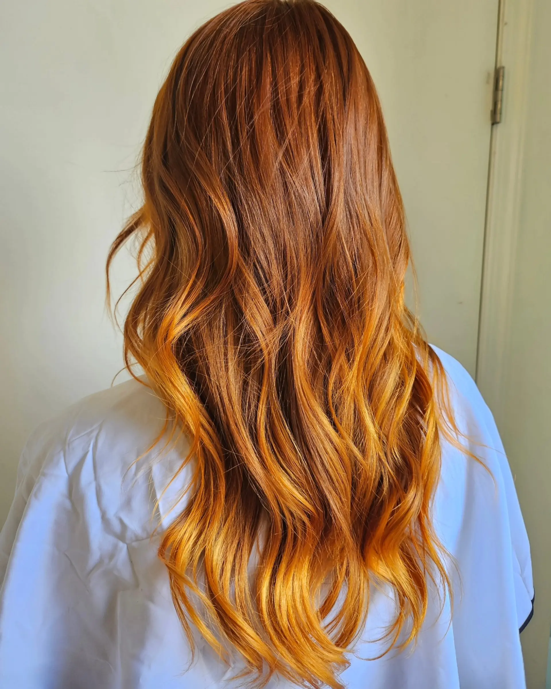 Rich copper-orange long hair styled in loose, flowing textured waves. 1