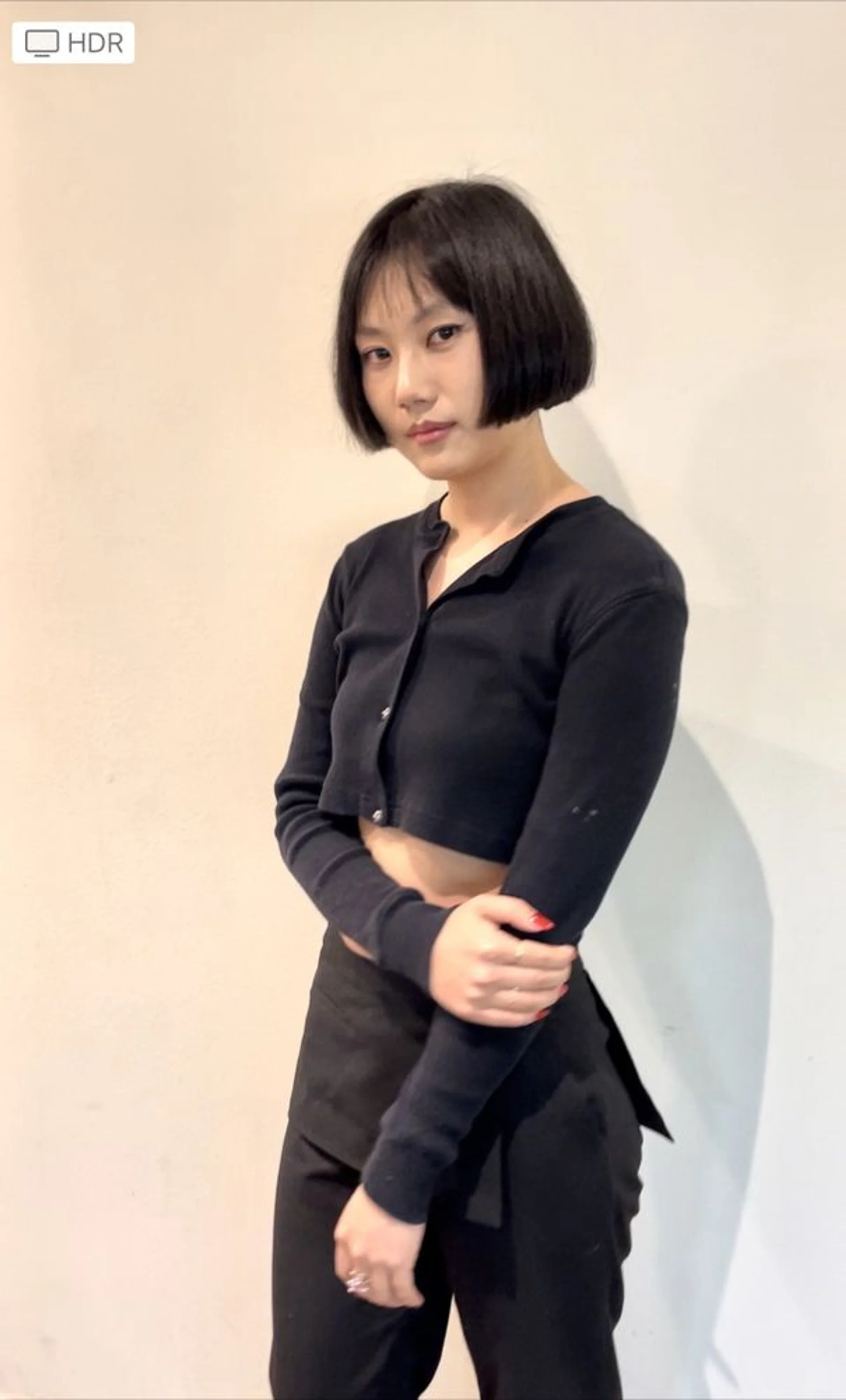 A woman sporting a sleek, blunt edgy bob with a bold straight-across fringe. - Preview 2