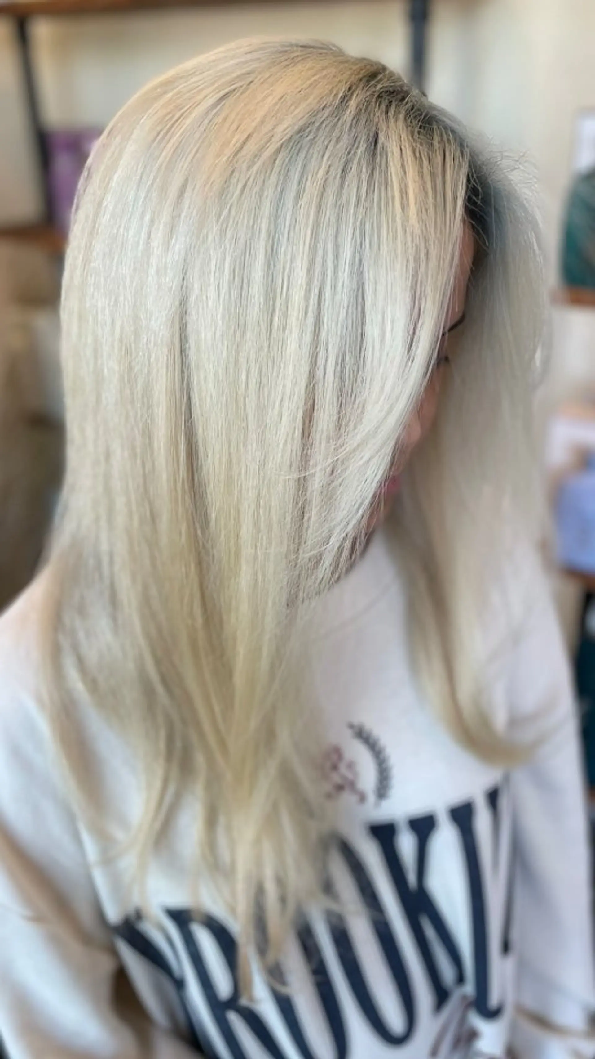 Straight, smooth platinum blonde hair styled with a sleek finish and subtle face-framing layers. 1