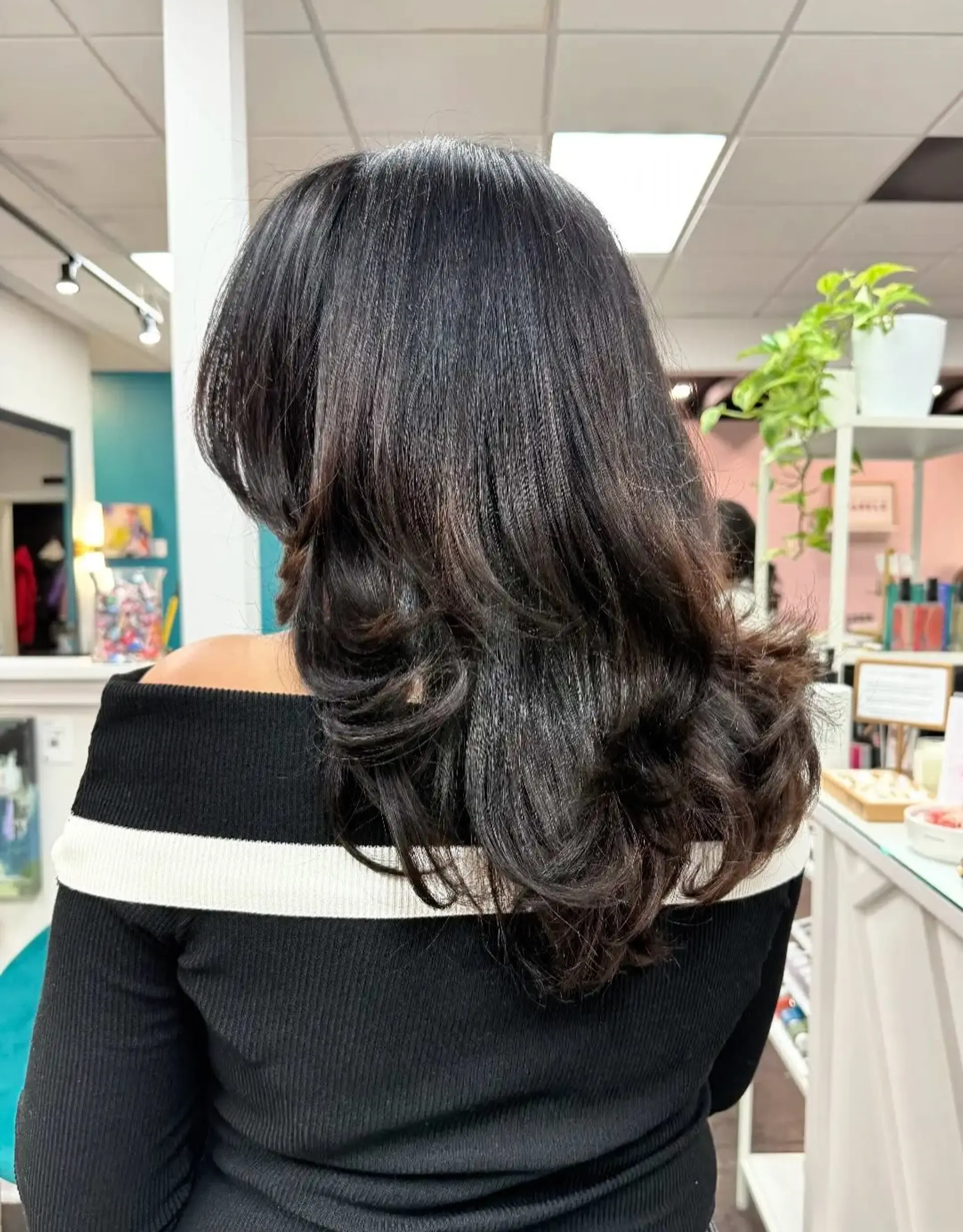 A long layered cut styled with a smooth blowout and voluminous, soft curls at the ends. 1