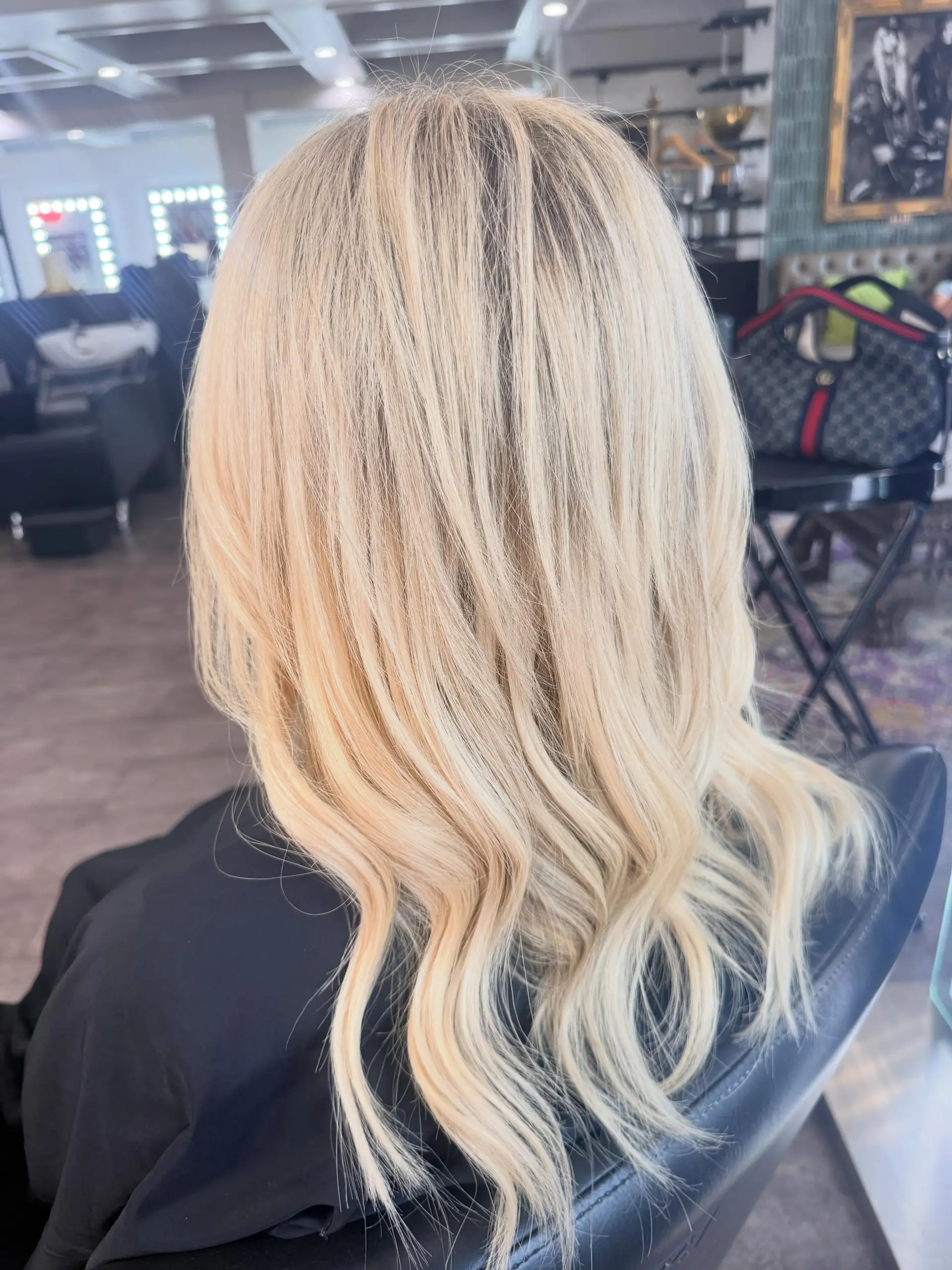 Long, light blonde hair styled in soft, loose waves with added volume and dimension. 1