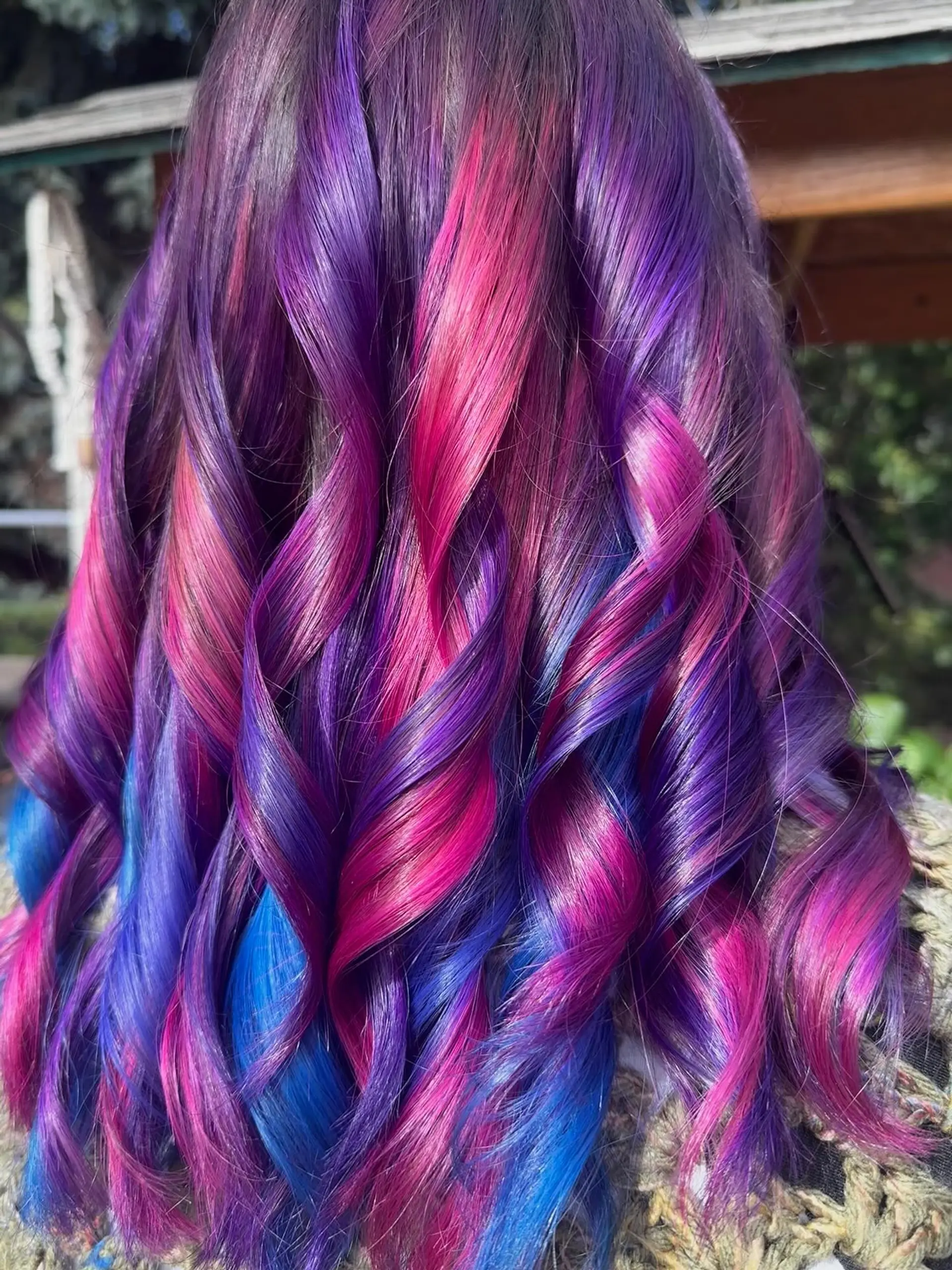 Vibrant vivid fashion colors blended in shades of magenta pink, deep purple, and electric blue, styled into shiny ribbon curls. 1