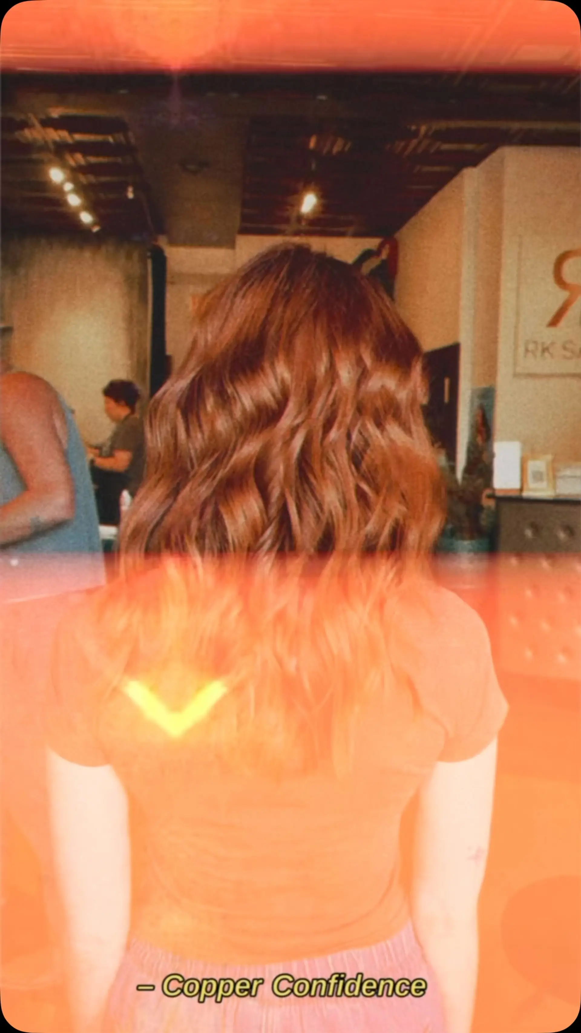 Medium-length dimensional copper hair styled in soft, defined waves. 1
