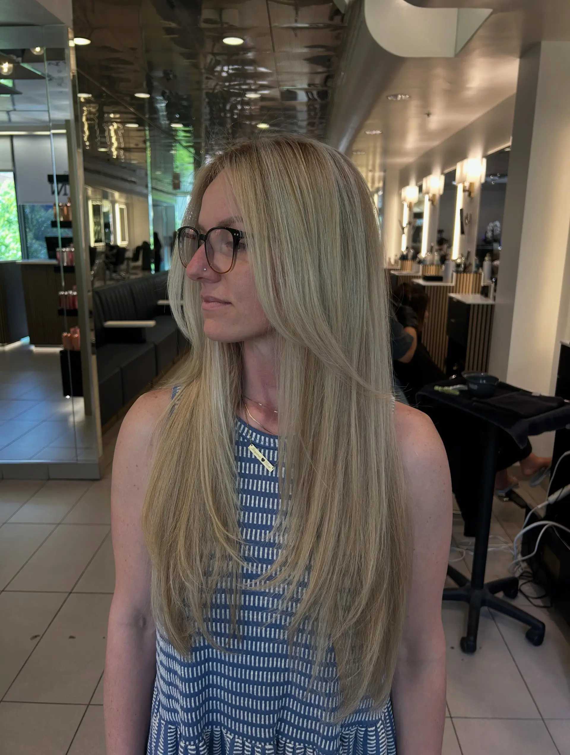 Long straight blonde hair styled with soft face-framing layers and feathered ends. 1