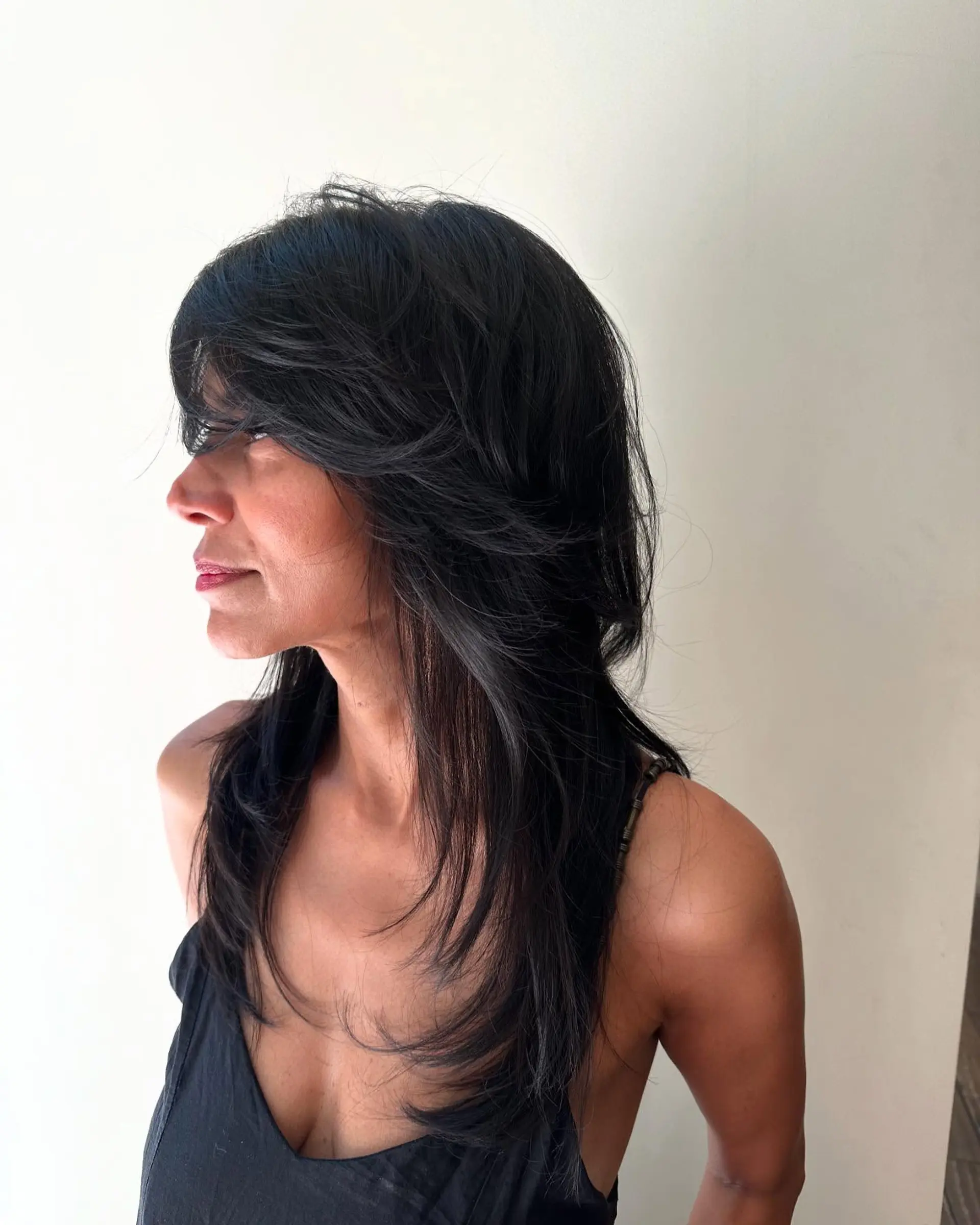 A long shag haircut featuring heavily textured crown layers, face-framing fringe, and feathered ends. 1