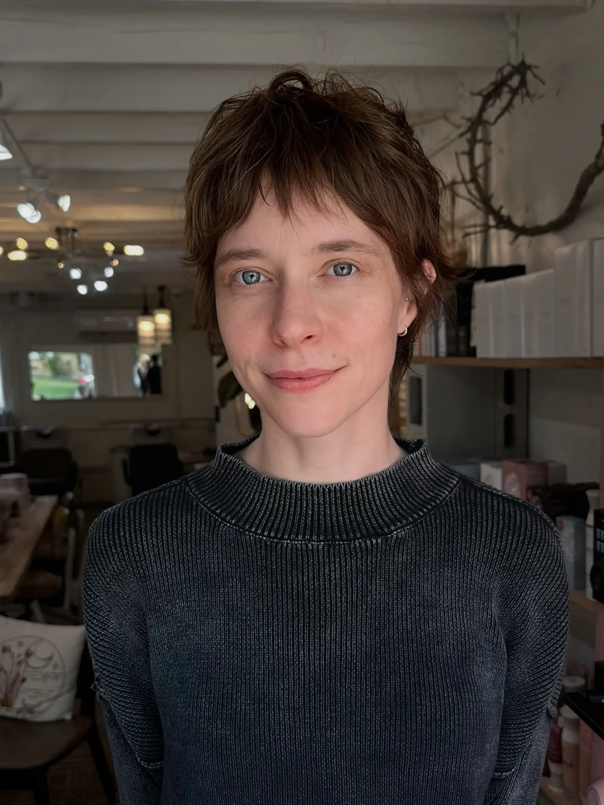 A soft, relaxed bixie cut featuring piecey bangs and choppy texture throughout. 1