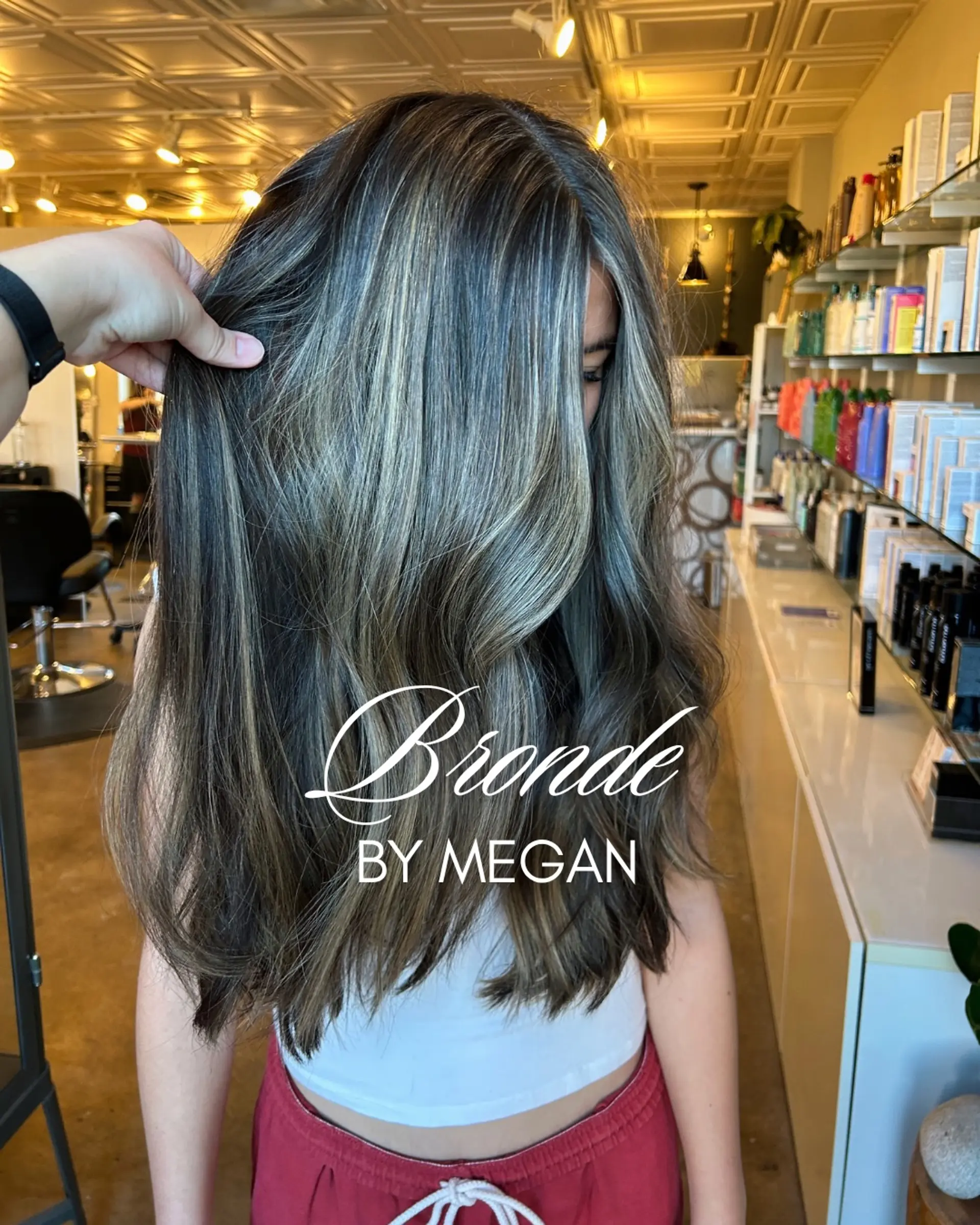 Long dimensional bronde hair featuring cool-toned blonde ribbons woven through a rich brunette base, styled in loose, soft waves. 1