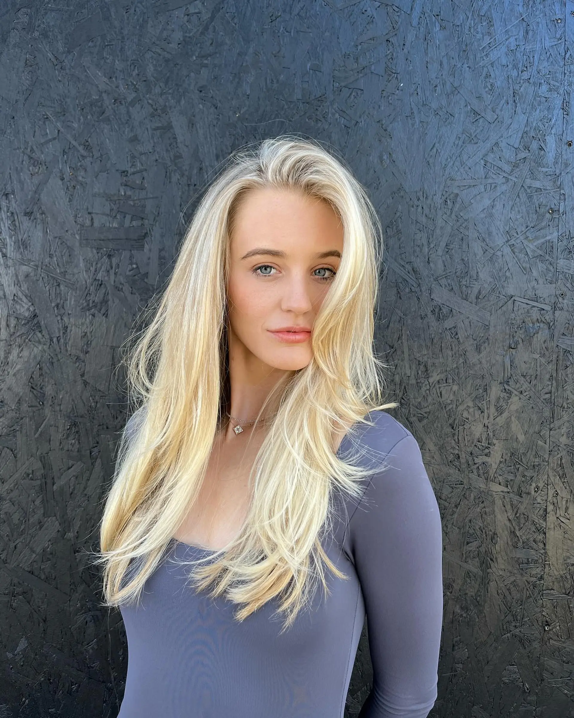 Long, bright blonde hair with soft face-framing layers and lightly flipped ends. 1