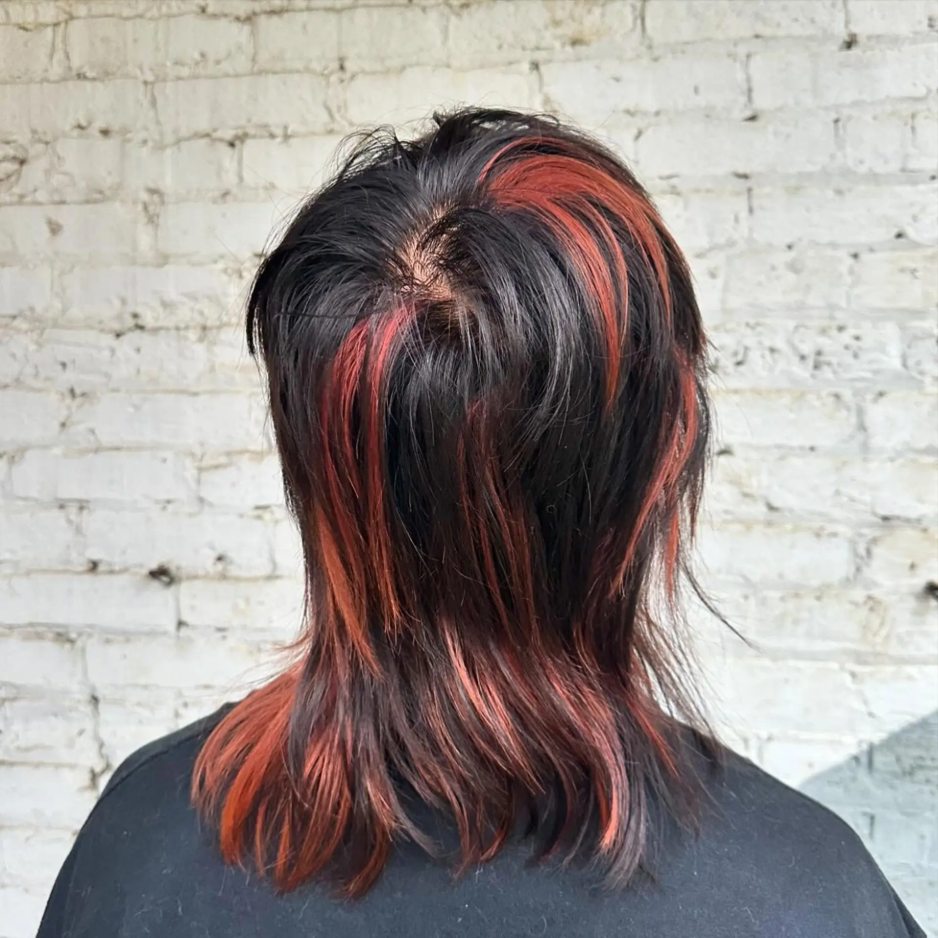 A trendy mullet with choppy layers and bold highlights. 2
