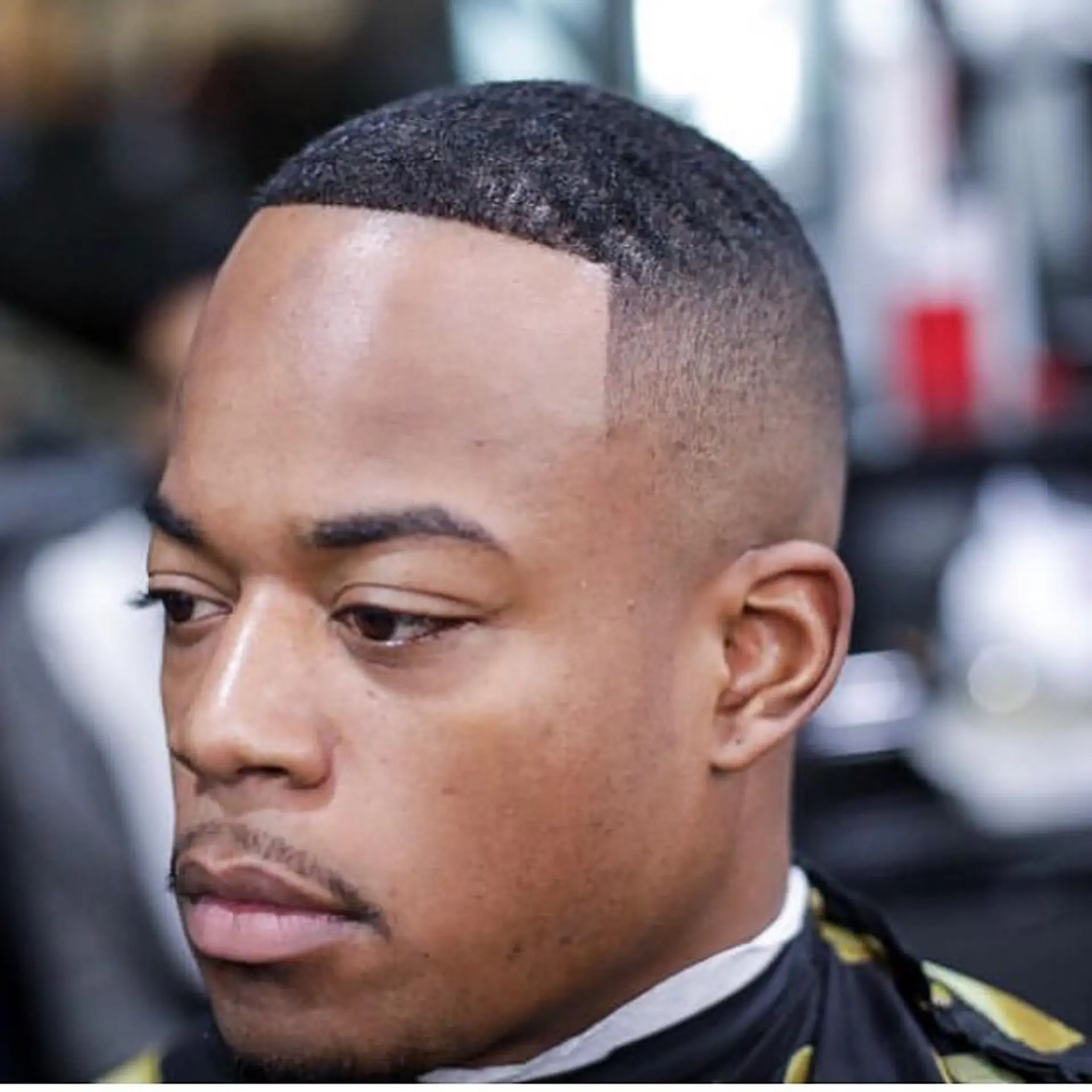 A crisp buzz cut featuring a high skin fade on the sides and a sharp, clean forehead line-up. 1