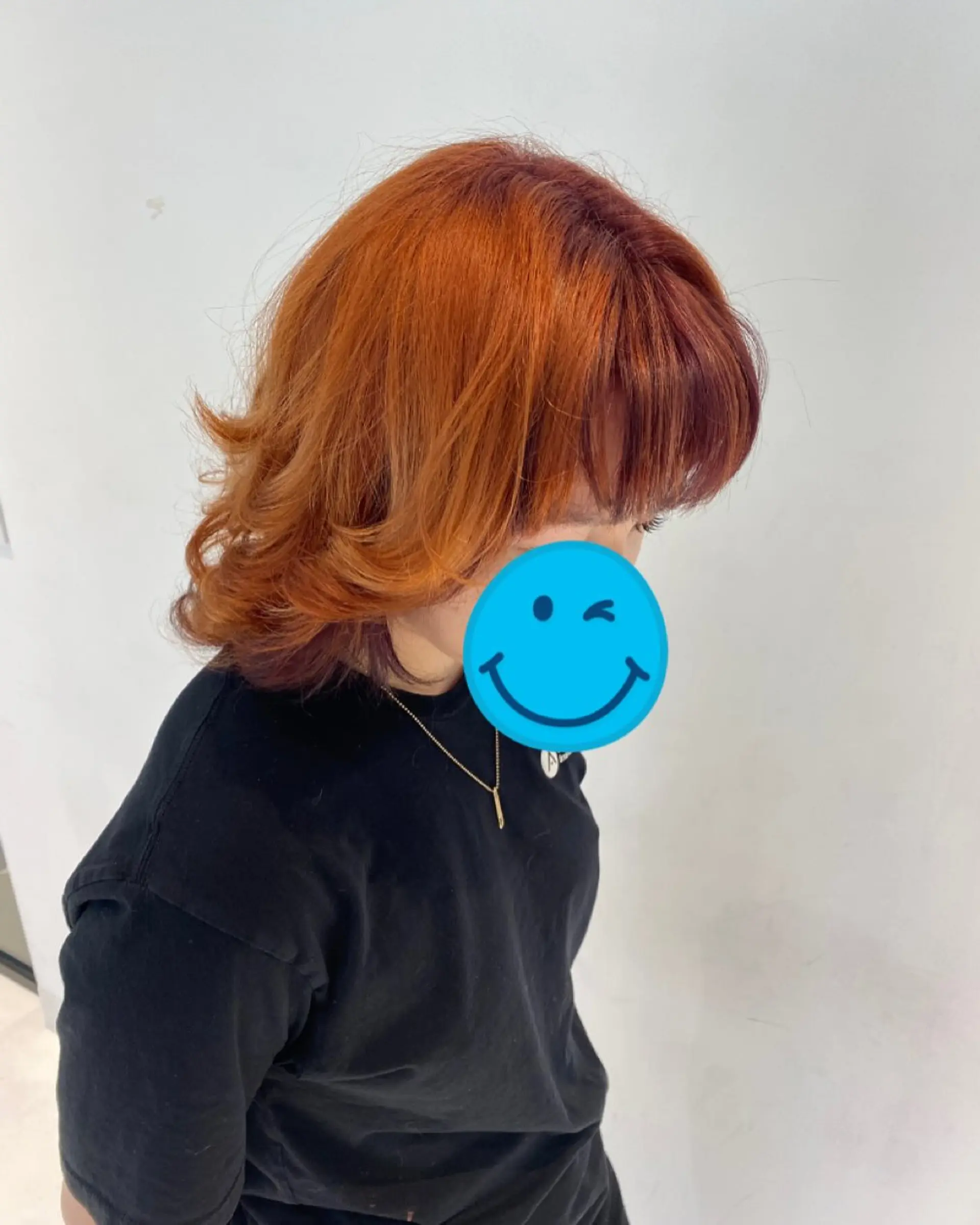 Medium-length layered copper hairstyle with outward-flipped ends and soft front bangs. 1