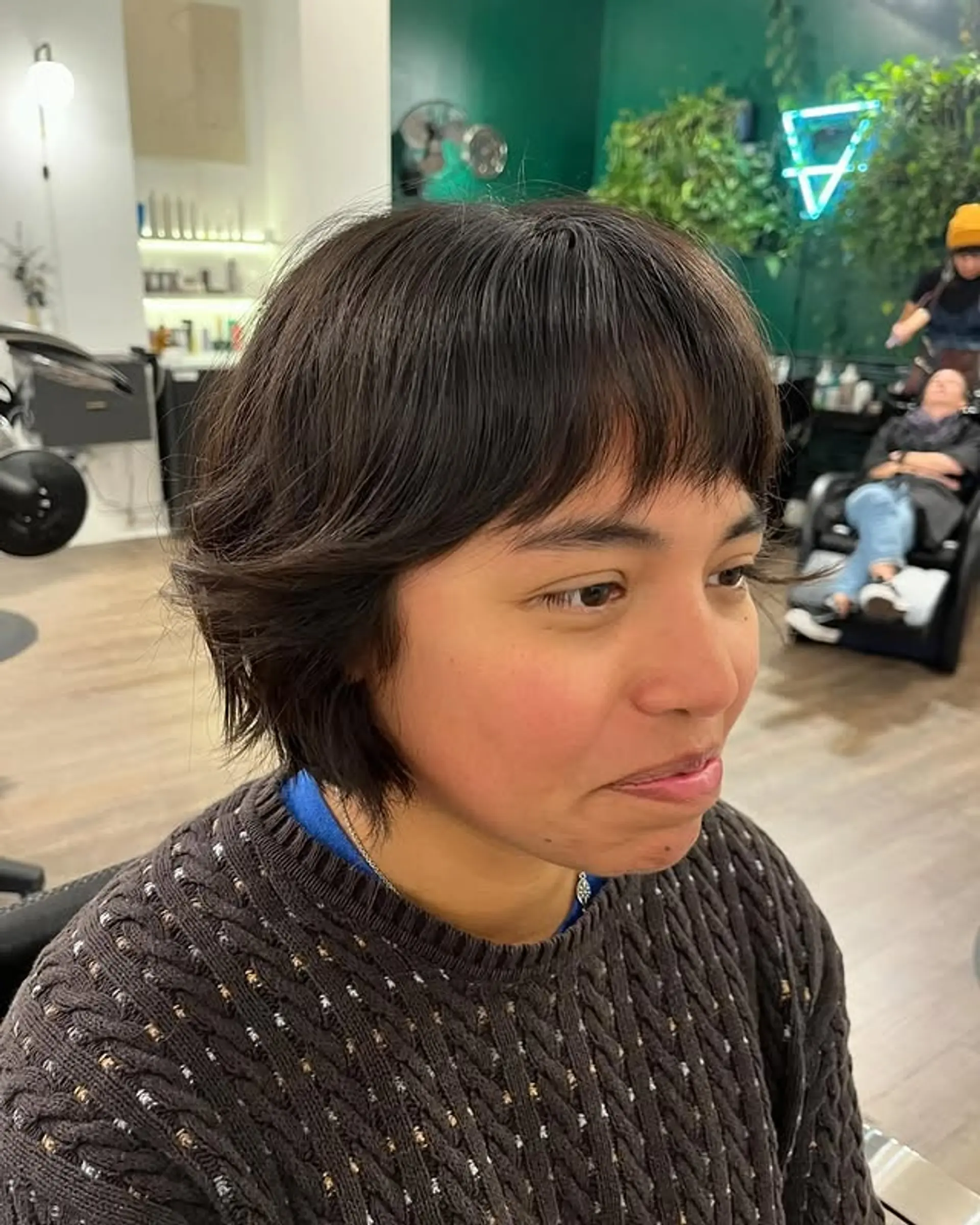 A modern, short blunt bob with textured layers and blunt fringe bangs. 1