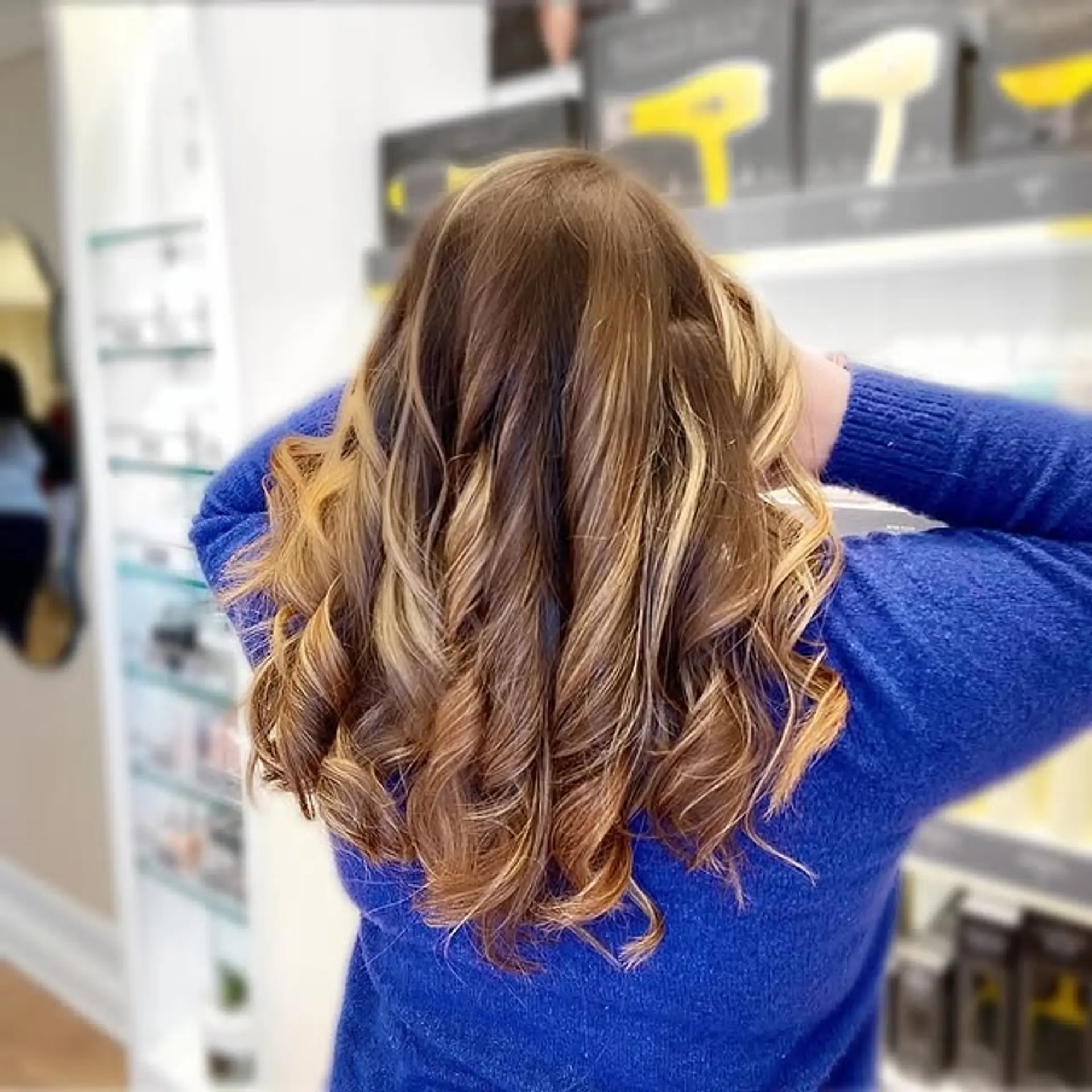 A wavy, medium-length hairstyle with a caramel swirl balayage. 1