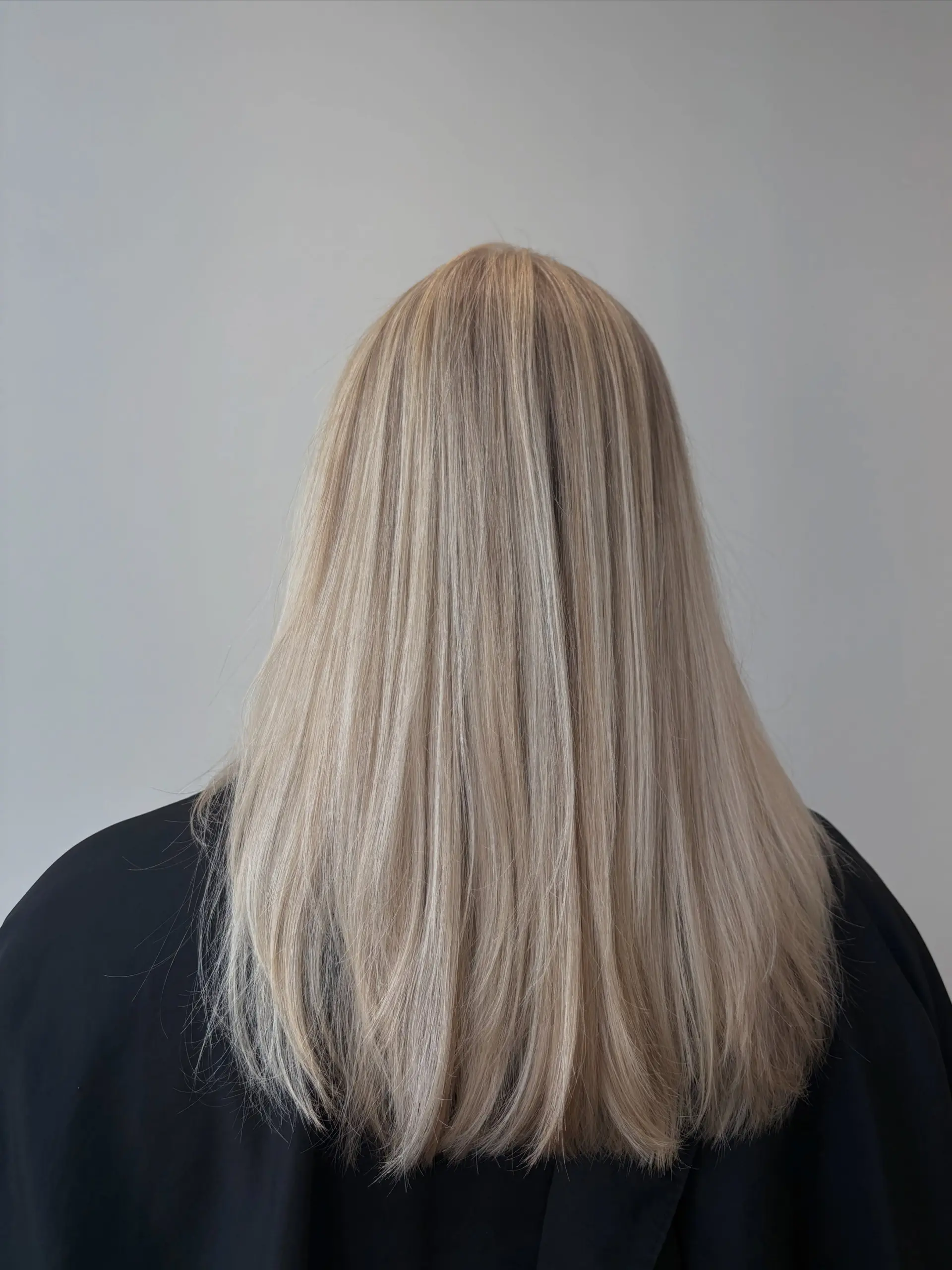 Long, straight ash blonde hair styled smooth with finely blended highlights and soft layered ends. 1
