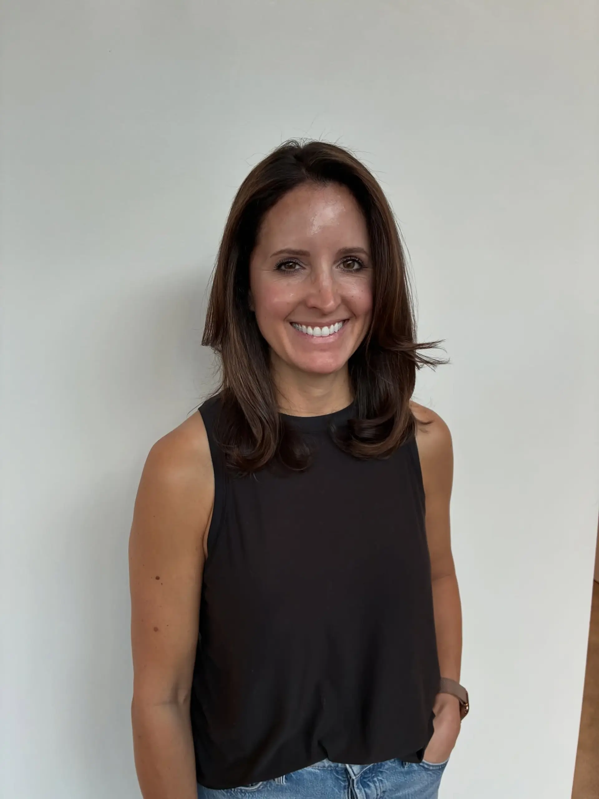 Shoulder-length rich brunette hair styled in a smooth blowout with subtle, warm dimensional highlights. 1
