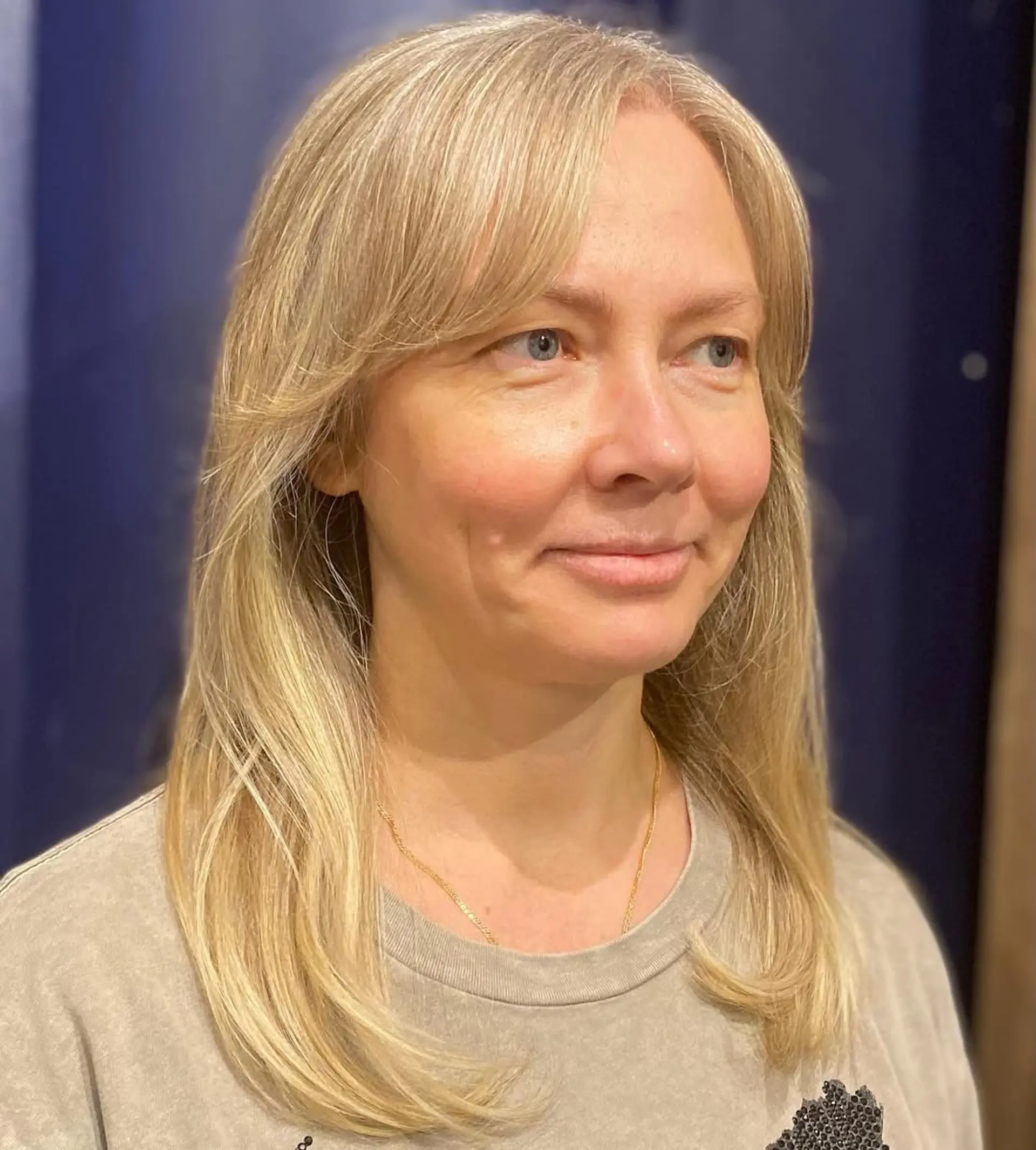 Long, straight blonde hair with honey tones, layered with side-swept bangs. 3