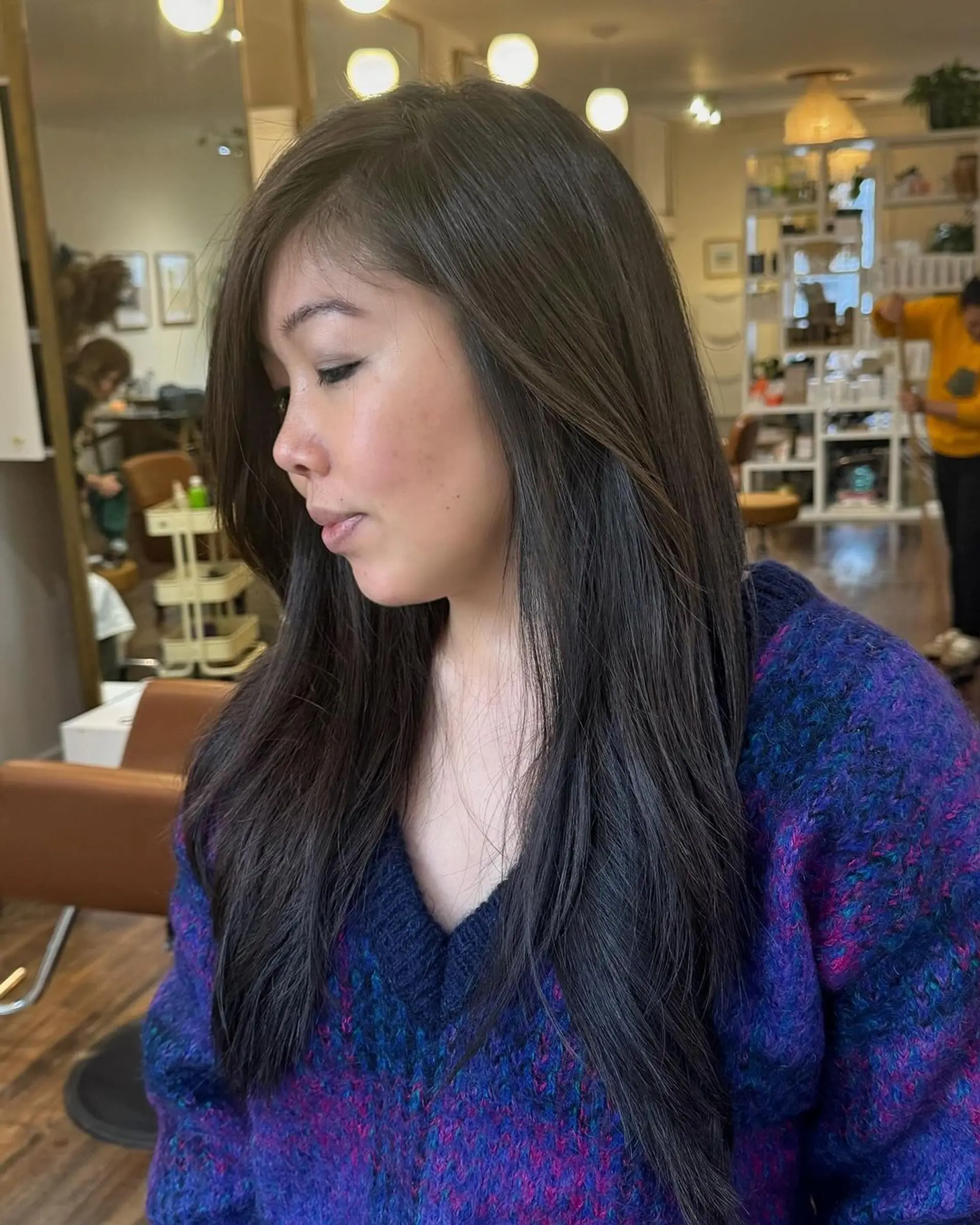 Long, straight dark brown hair with a smooth finish and a side part, layered subtly at the ends. 1