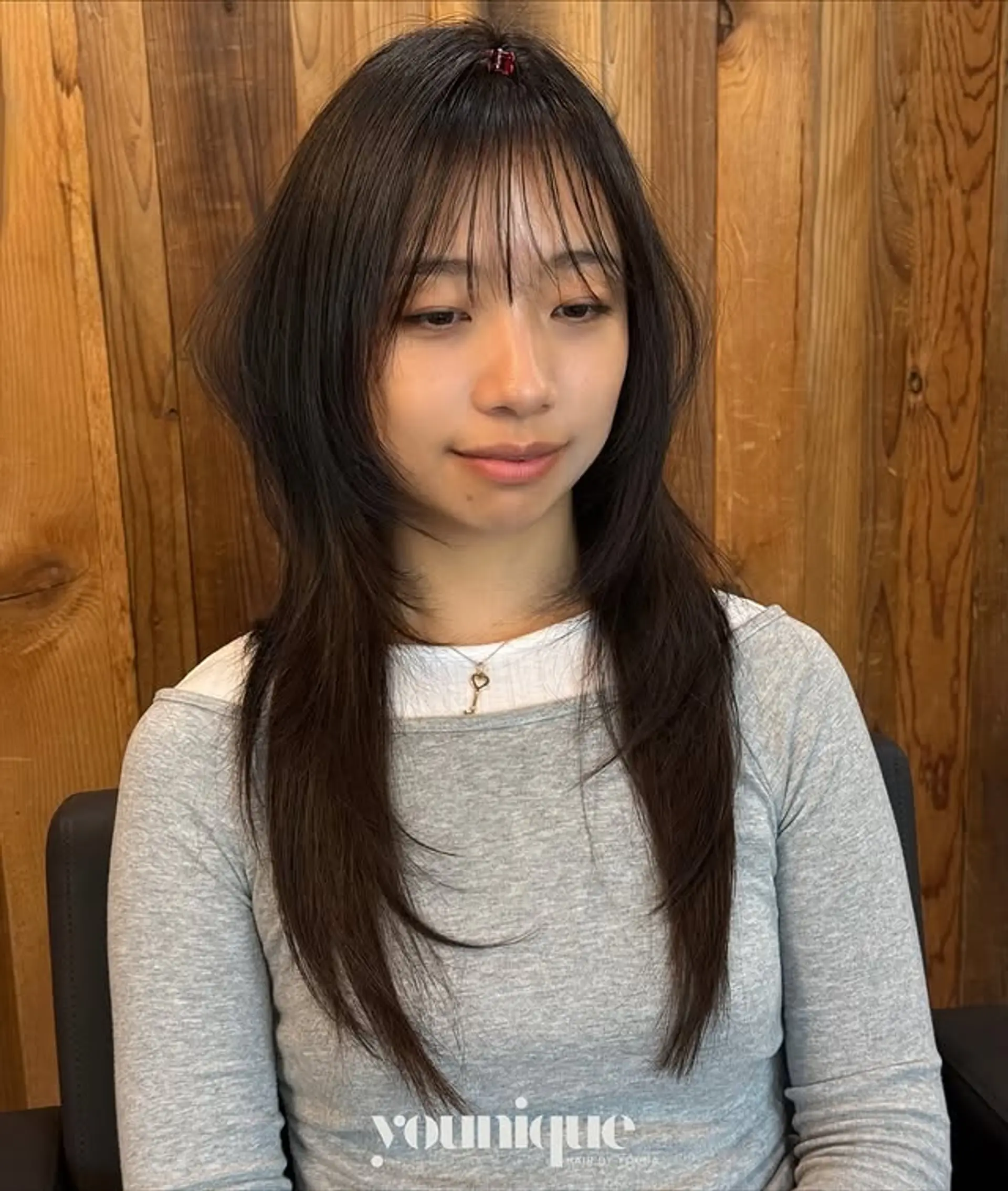 A long, layered haircut with wispy bangs and face-framing layers. 1