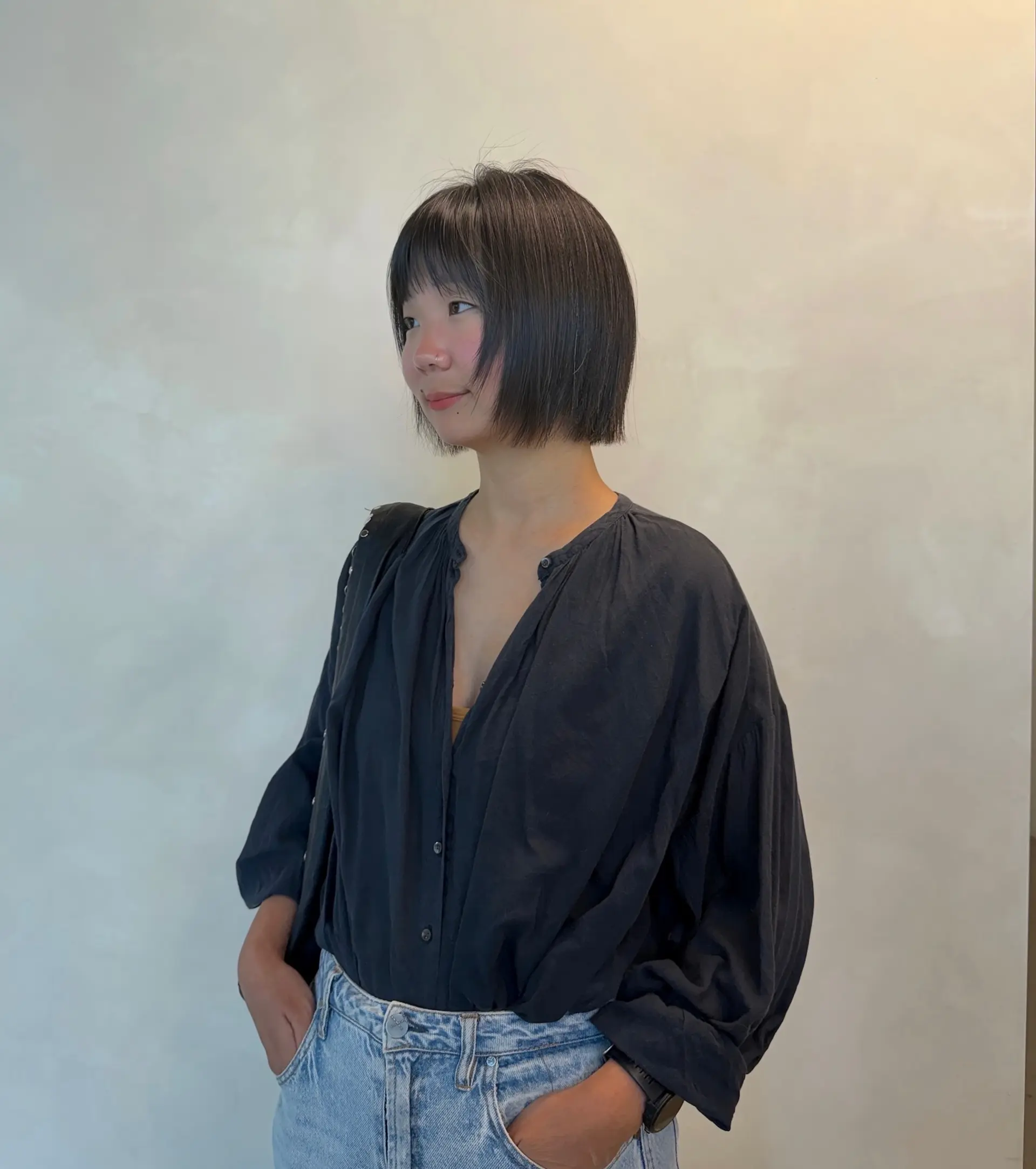 A sleek, chin-length straight tassel bob with wispy bangs and light, textured ends. 1