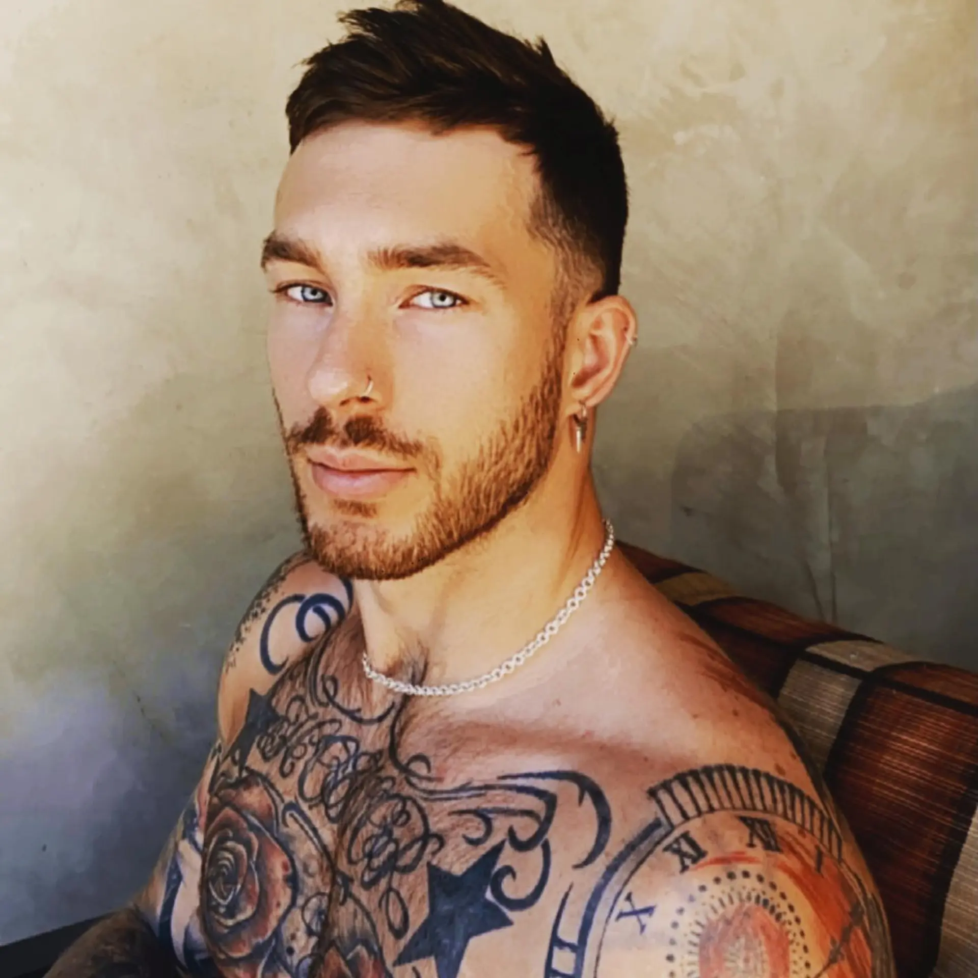 A short men's haircut with clean tapered sides and a choppy, textured top styled forward. 1
