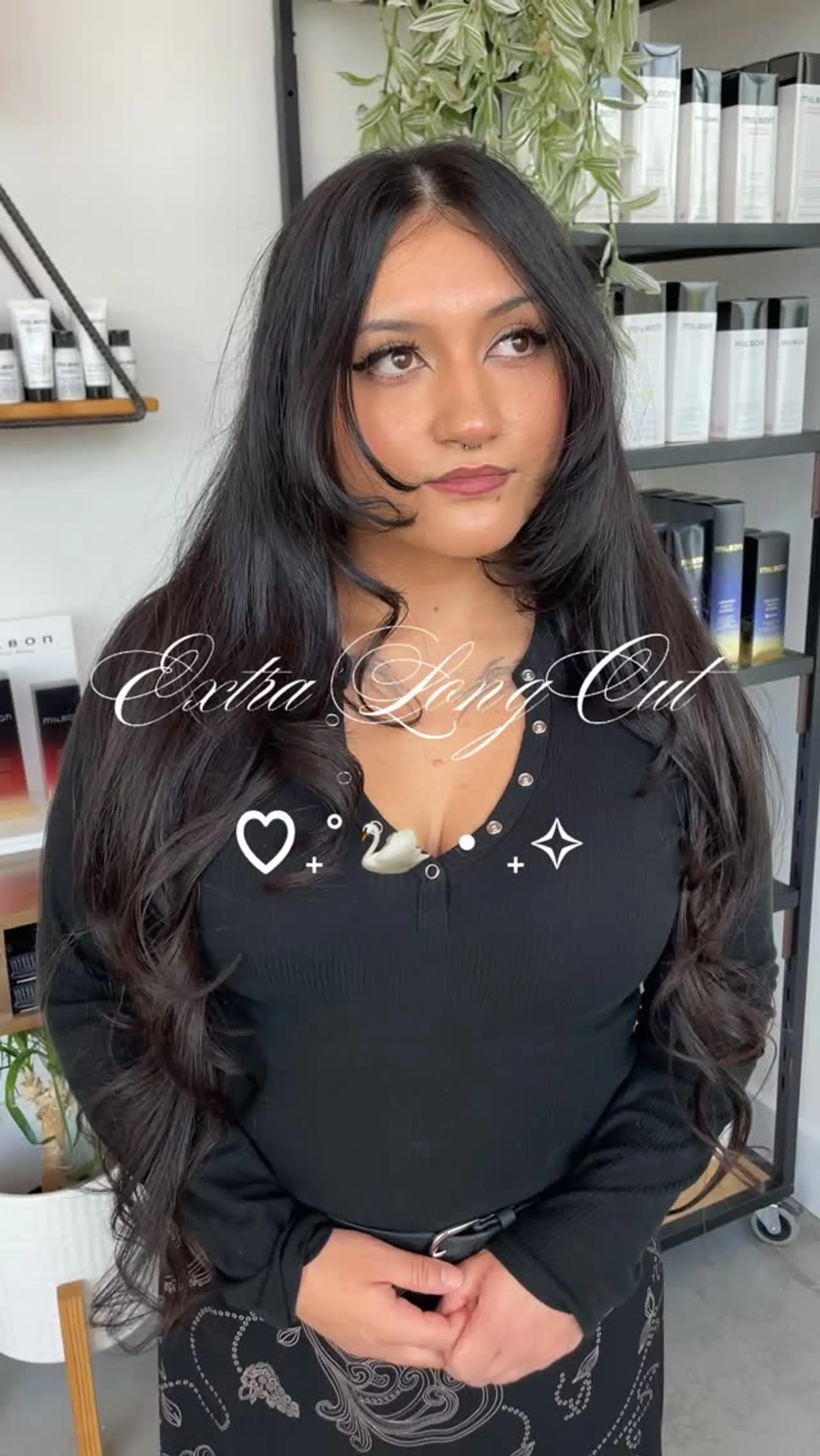 Extra long dark hair featuring face-framing curtain layers and soft loose waves. 1
