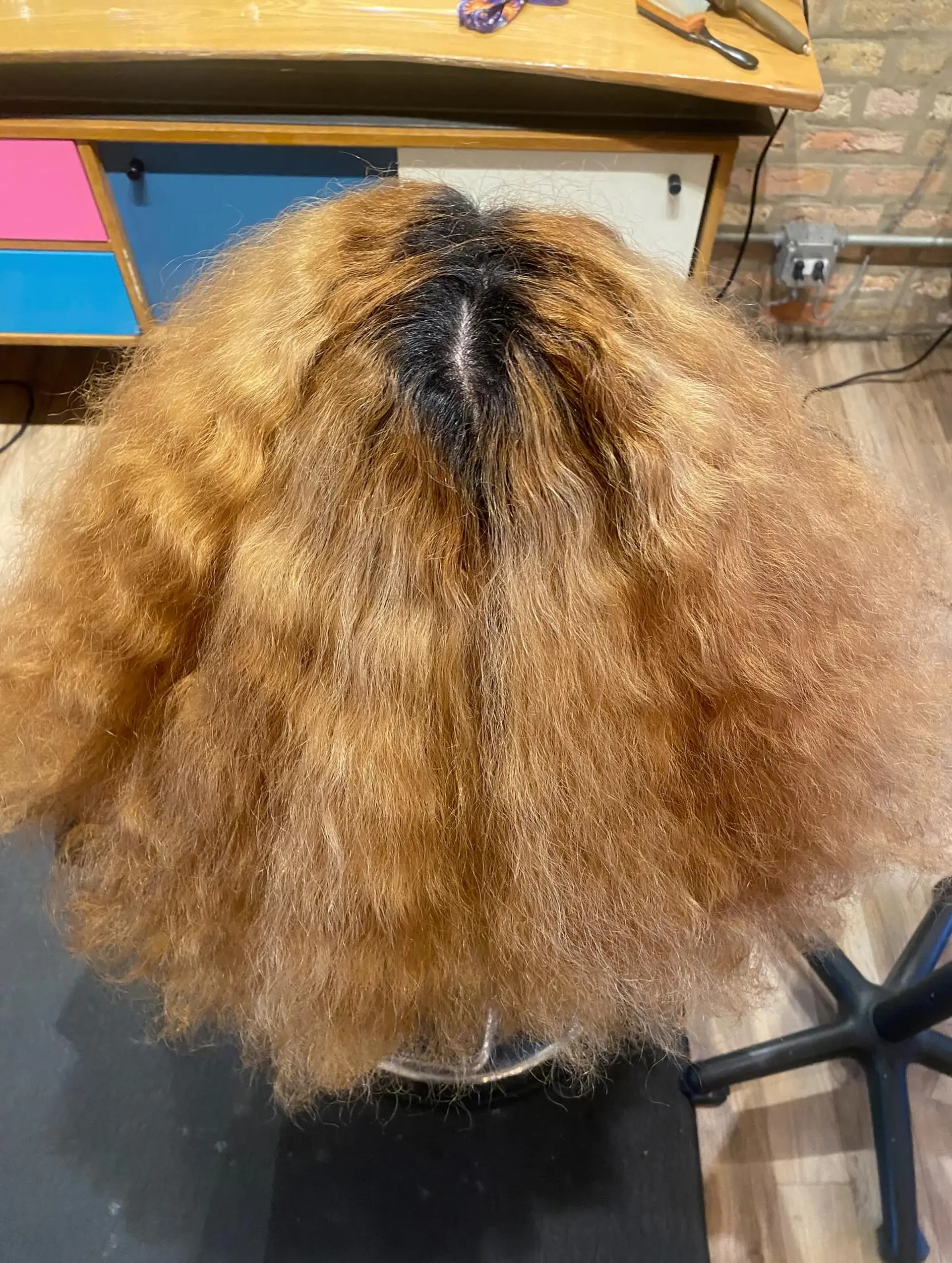 A stylish, medium-length bob with bouncy, defined curls and a rich copper color. 4