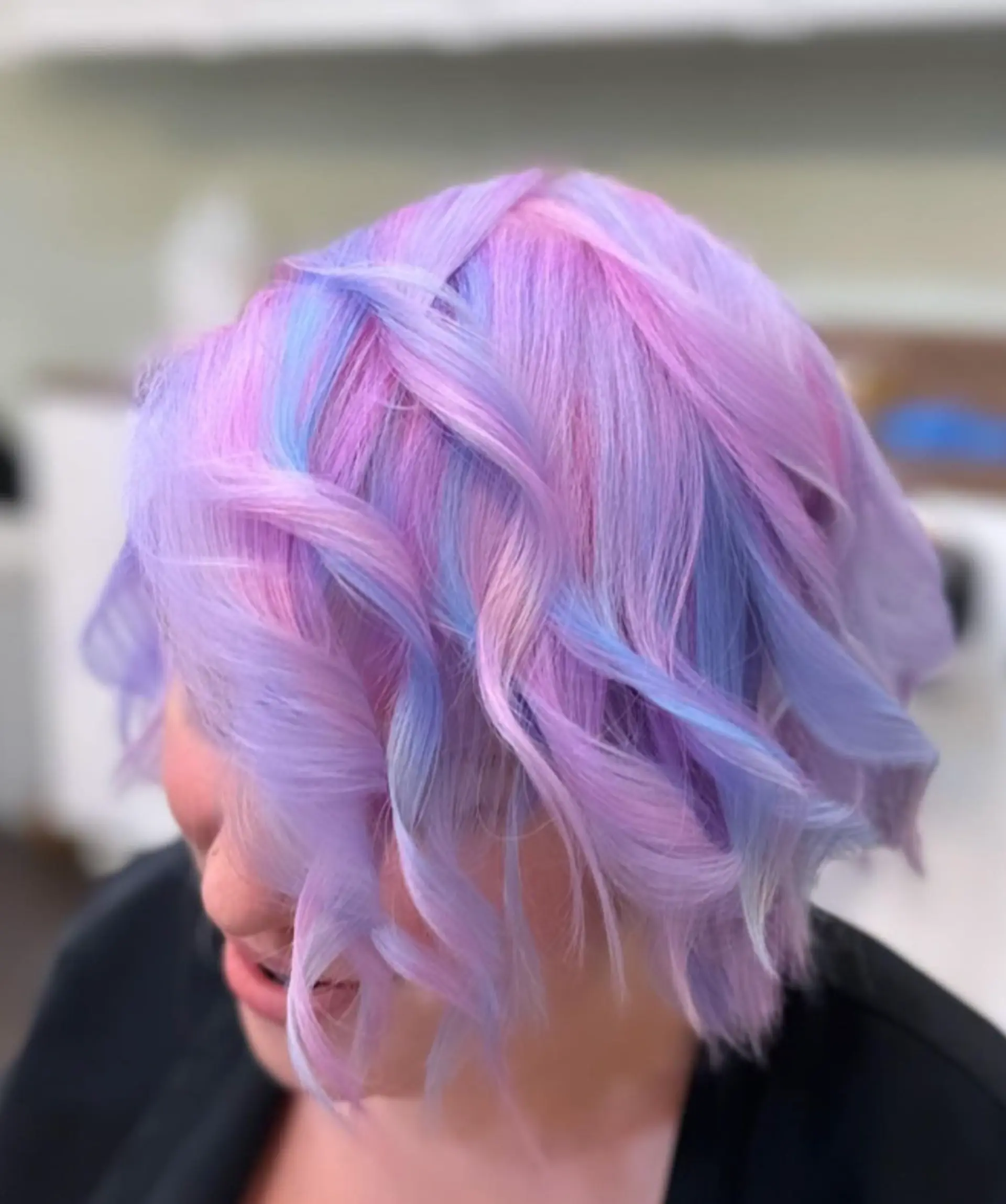 Short, wavy bob with pastel pink, blue, and purple hues; multi-dimensional and whimsical look. 1