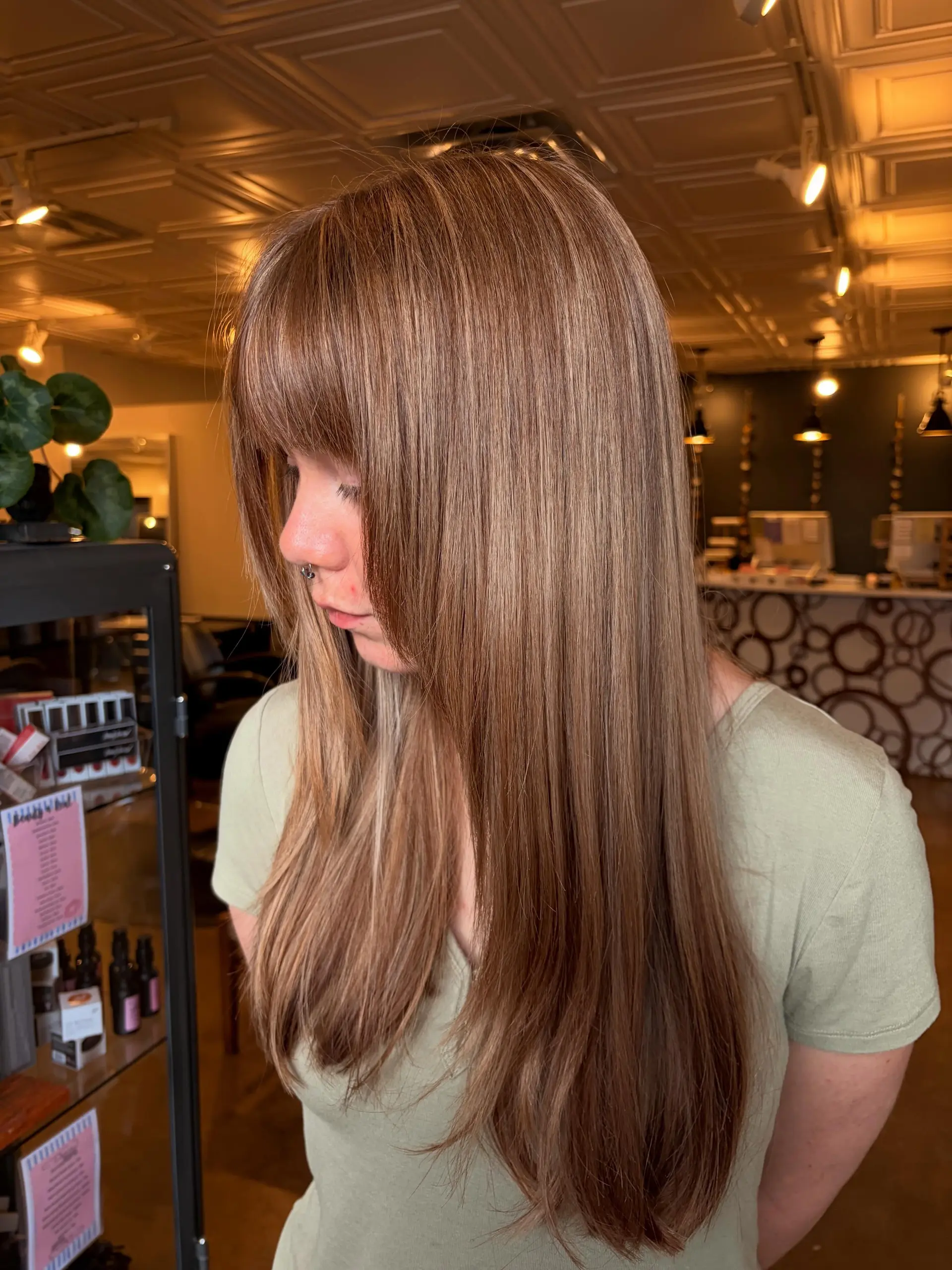 Long straight hair with seamless buttery highlights and full eye-skimming bangs. 1