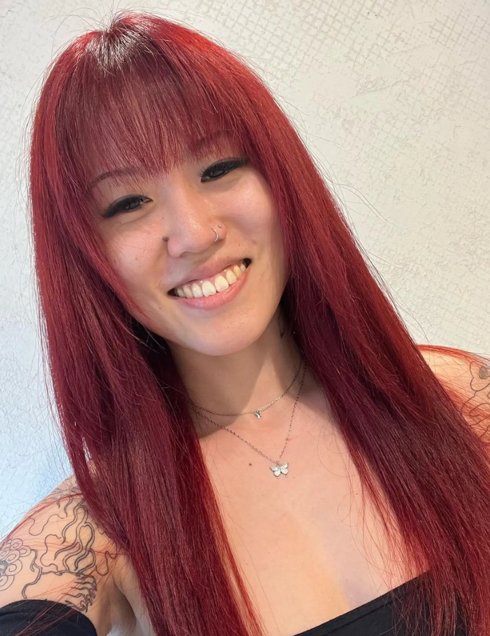 An elegant long hairstyle with vibrant red color, straight texture, and full fringe bangs. 1