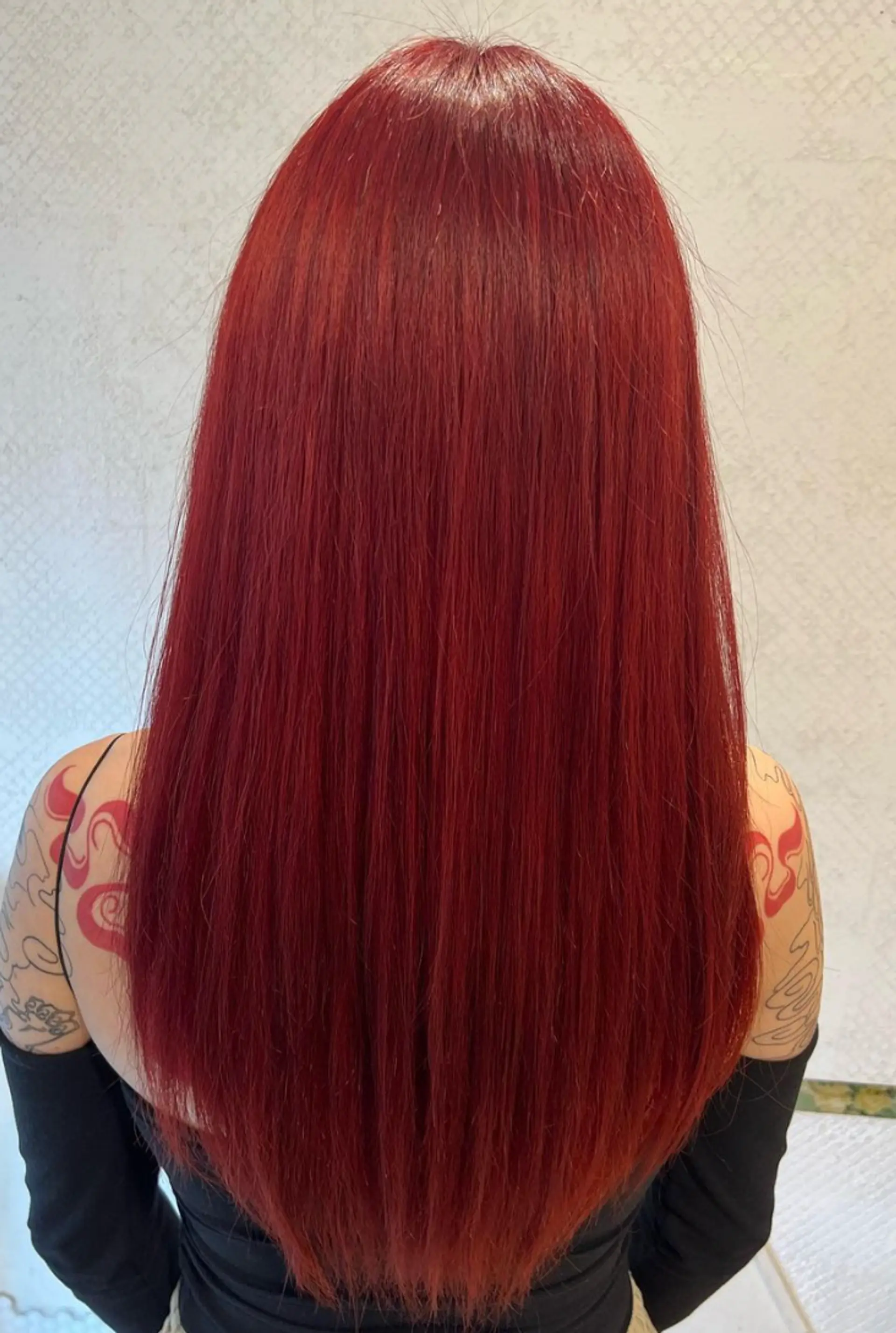 An elegant long hairstyle with vibrant red color, straight texture, and full fringe bangs. 2