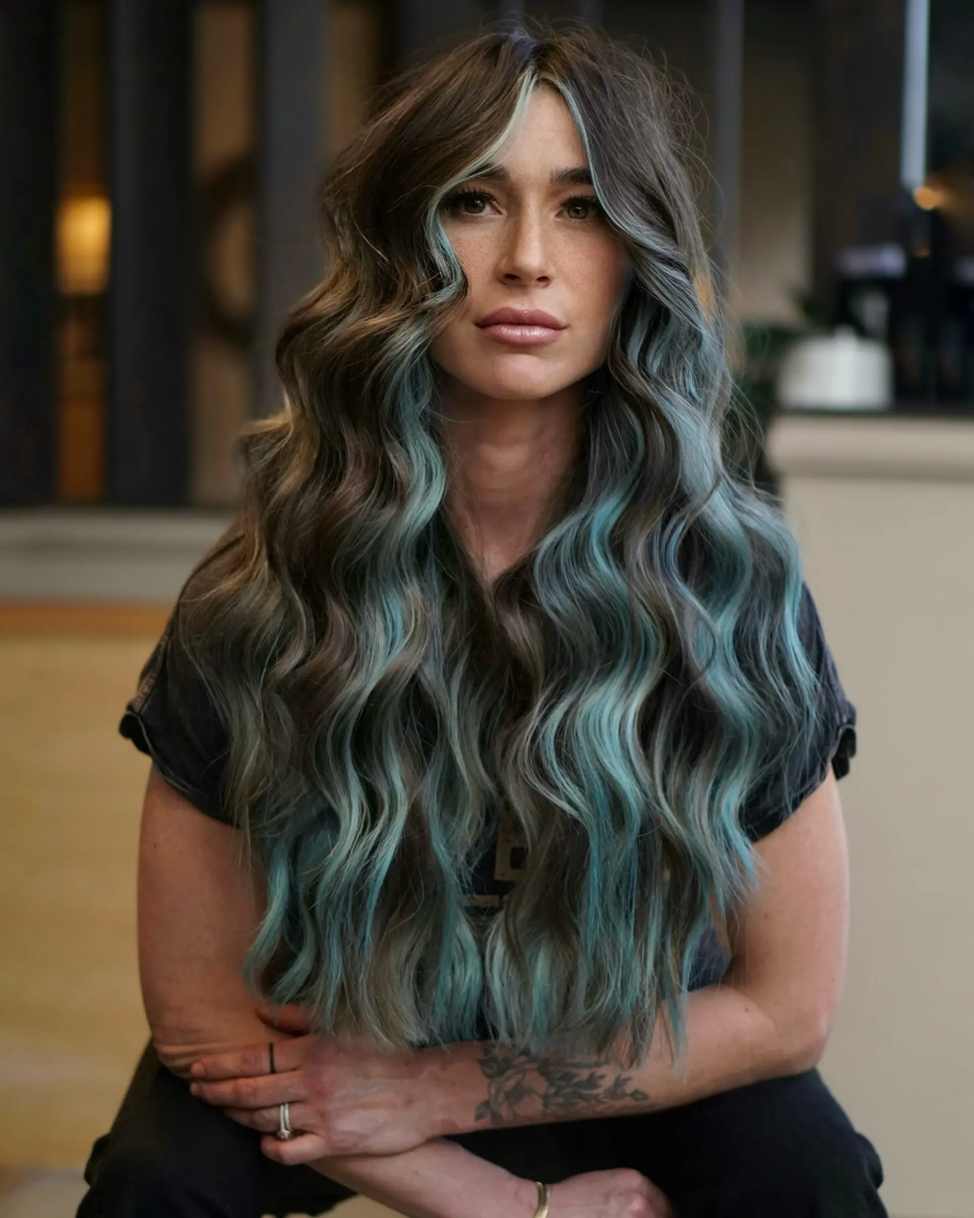Rich espresso brown hair styled in long, flowing waves with contrasting pastel baby blue face-framing highlights and dimensional ribbons. 1