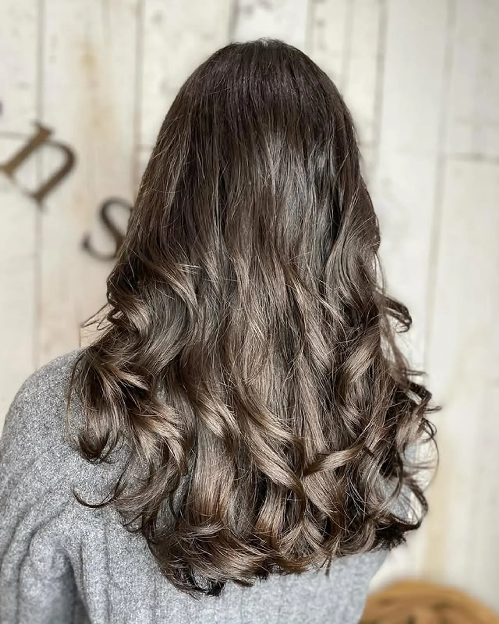 Long, layered hair styled into loose, romantic waves. 1